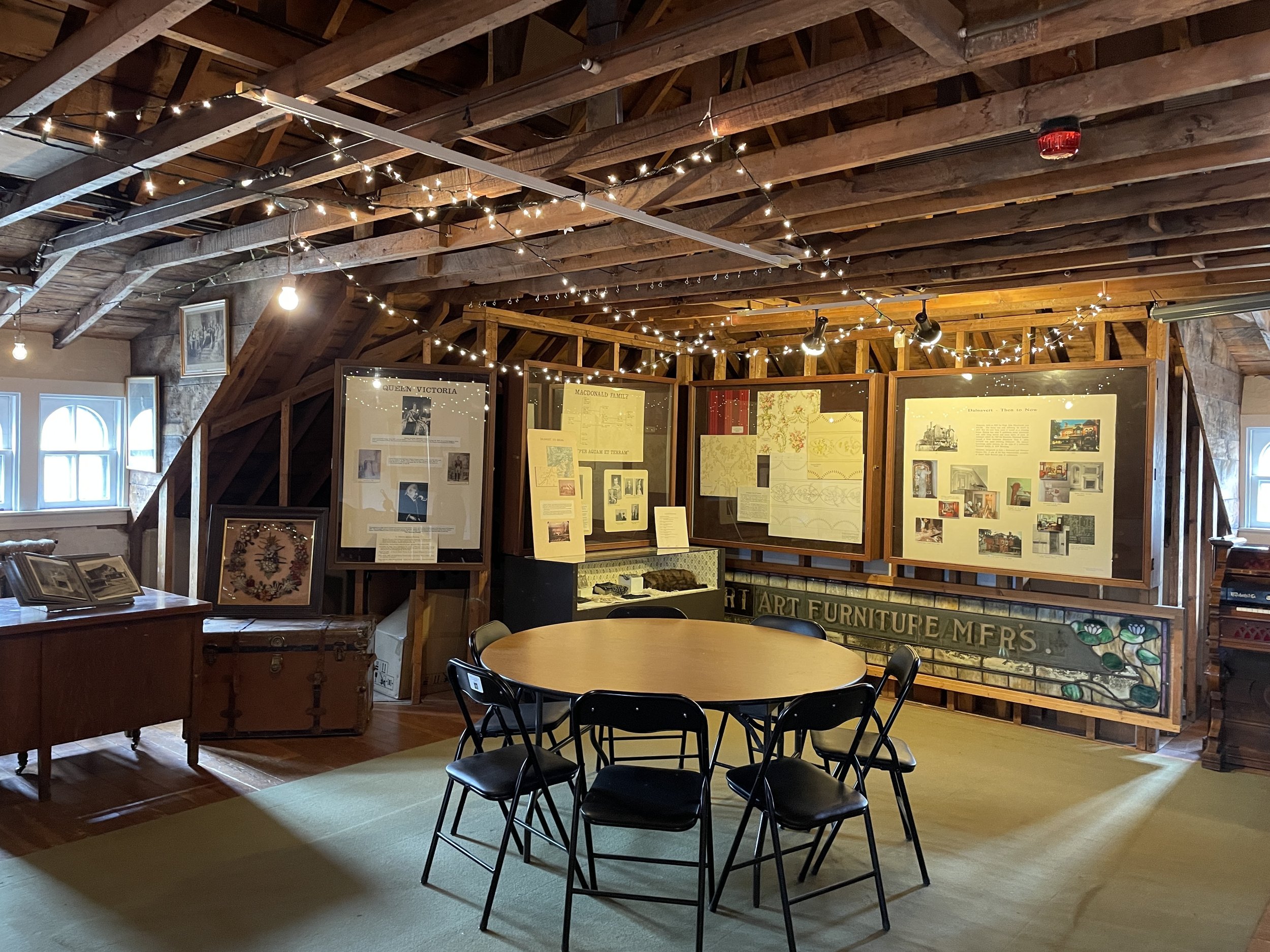  Dalnavert’s attic with one table set with chairs around it in the centre of the room. 