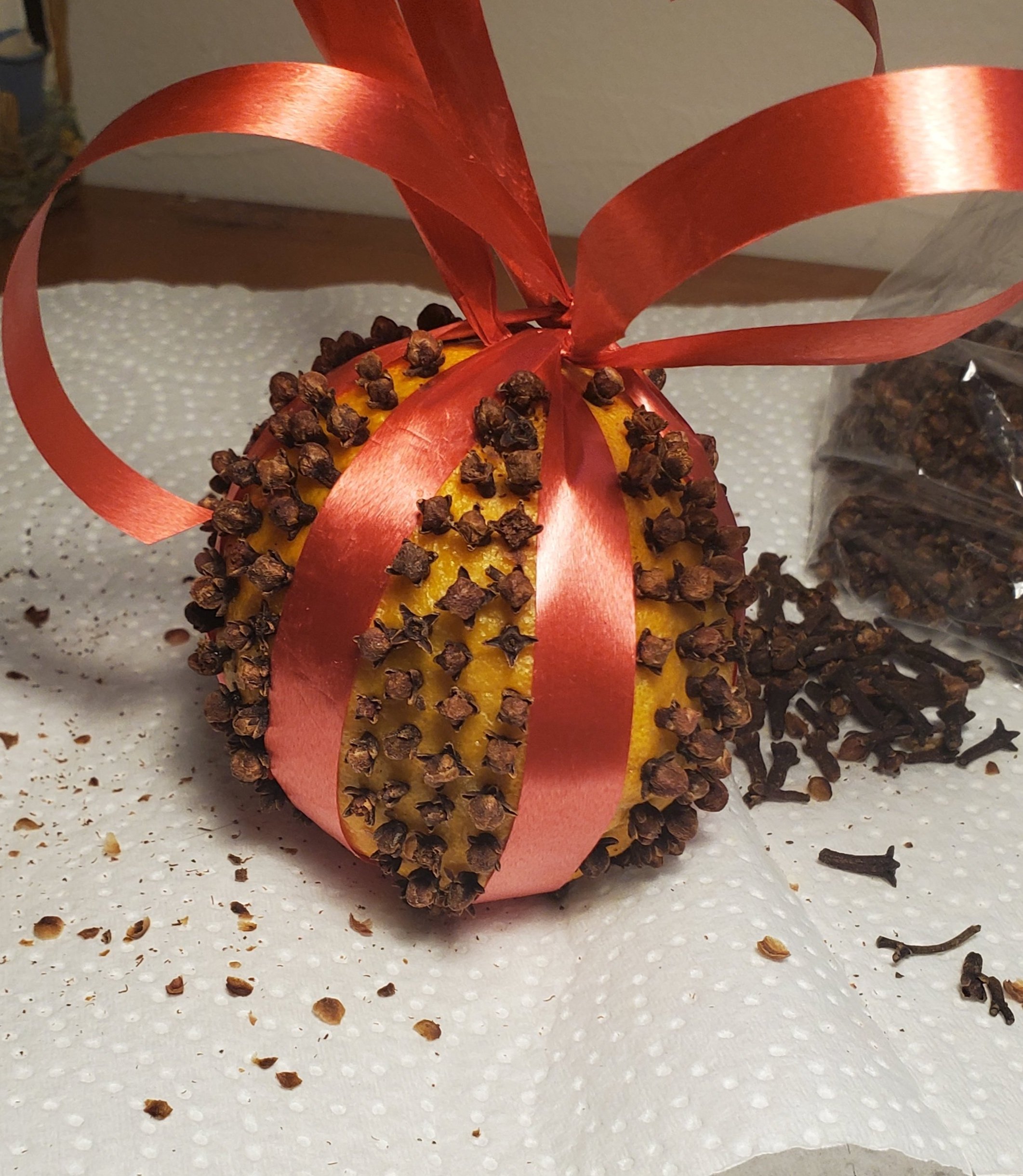  Once you feel like your pomander is finished, attach a hook to hang it from the tree or hang it by the ribbon.&nbsp; 