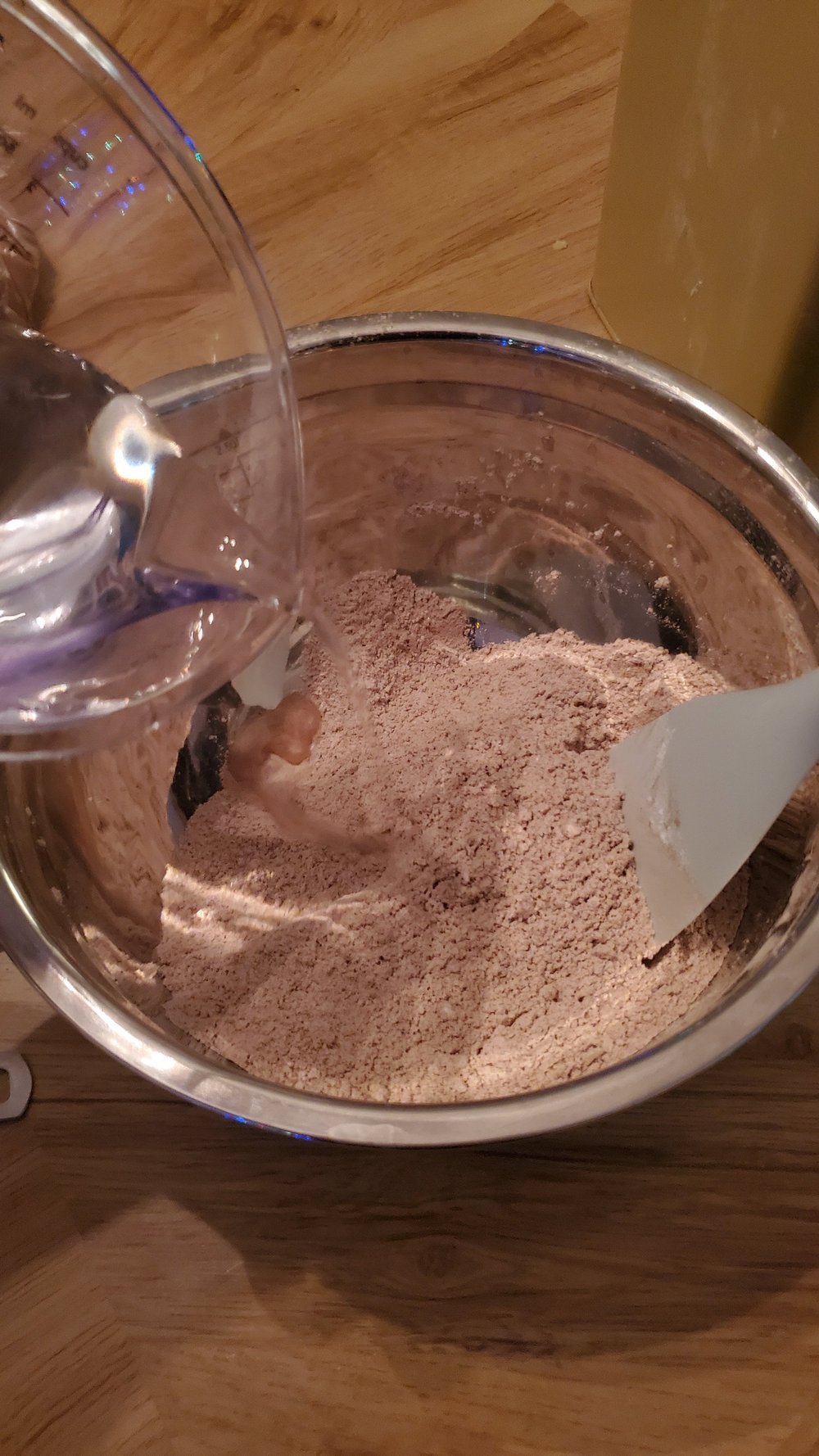  Slowly mix the water into the dry ingredients. 