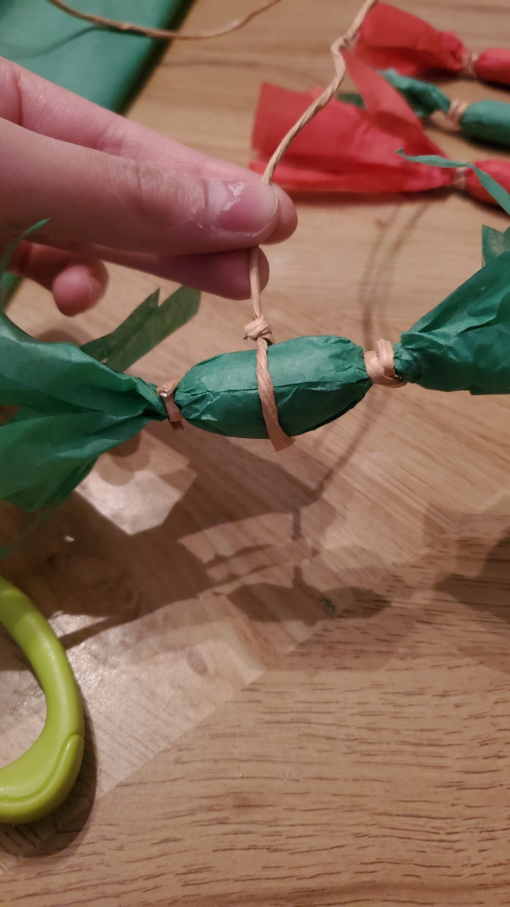  Tie a string around the middle of a peanut to make the bottom of the peanut ornament  