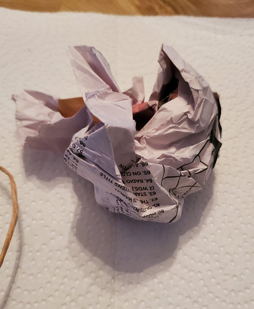  Take half a sheet of unripped newspaper and scrunch it into a tight ball 