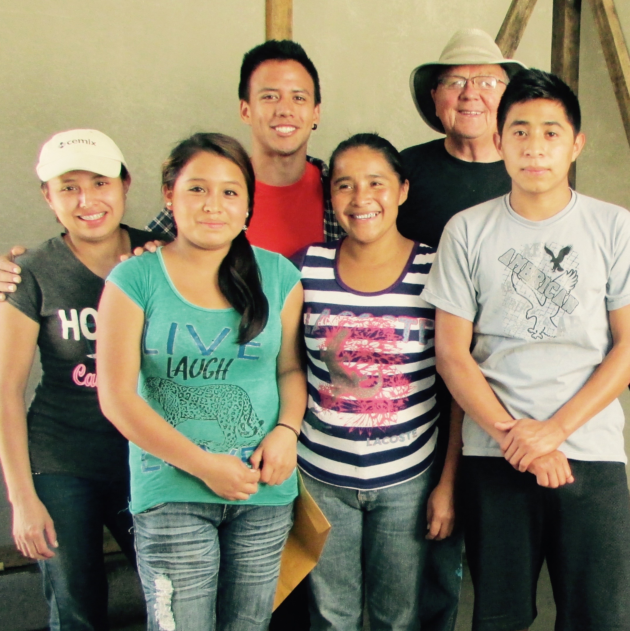 Maria inside her new home with her four children and a volunteer helper