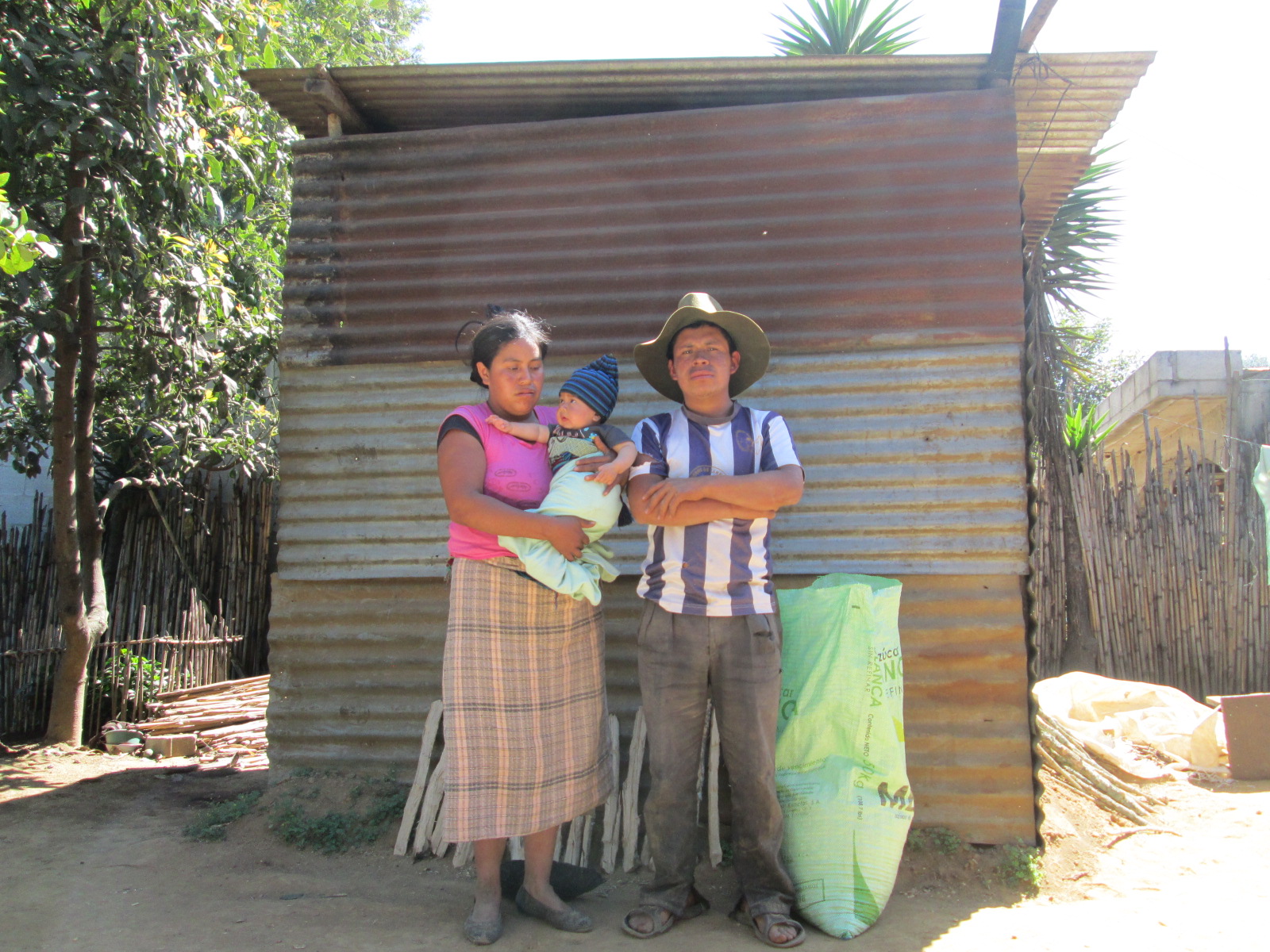  Family in front of previous shelter 