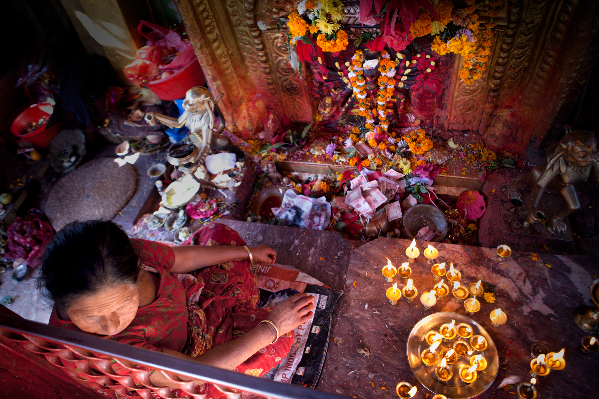 Nov 16.1, 2016 At the edge of the Bishnumati River we enter a small Buddhist temple off Thapkia route. It's easy to be respectful but hard to not feel out of place. I make an offering to the Stupa, an observance of the Three Jewels (or Refuges). I spent six months this year living in a Buddhist temple, each morning began with a chant of the Three Refuges in Sino-Korean. These are the Buddha, the Dharma, and the Sangha; the cornerstones of all Buddhist forms; our own Buddha nature, the ultimate Truth and Middle Way, and our community. For my offering I was pointed towards a plate of red vermillion paste and proceeded to apply a small dash of it onto my Third eye—between each eyebrow—a mark known as a tilak (pronounced /ˈtilæk/). Of its many meanings, one is to serve as an auspicious mark of a great journey or campaign.