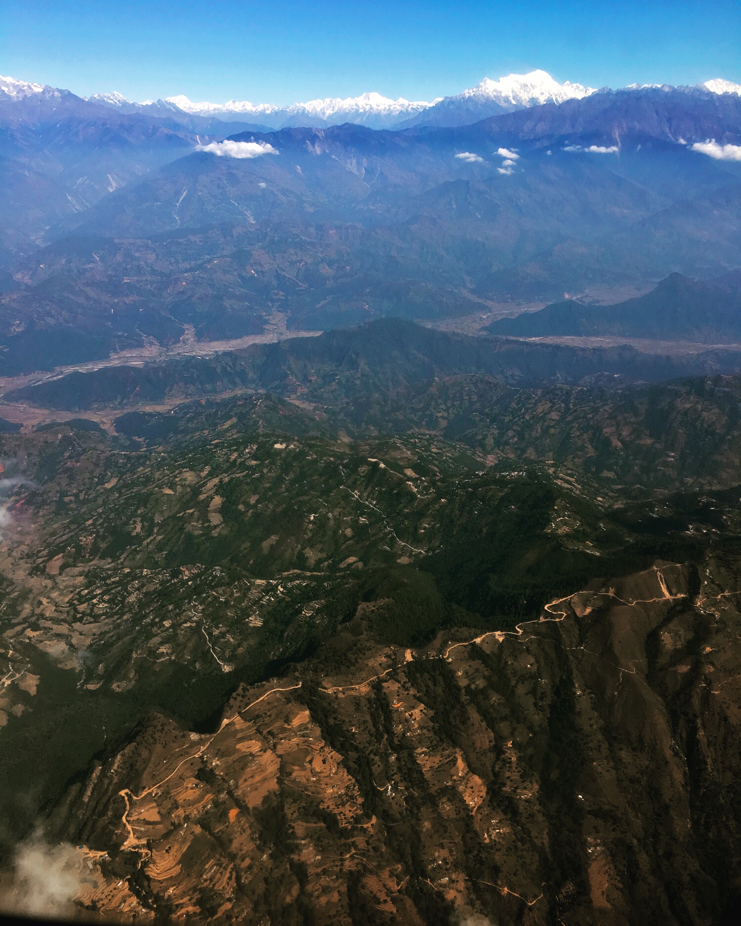 Nov 17.2, 2016 From the air Nepal remains lined by prayer flags atop small village homes and coursing down disparate rounded temple stupas. I can see the long, serpentine road that connects Kathmandu to Pokhara. Those famous gateways to the Himalaya; those places where modest dreams meet the floor and ceiling of the Earth.