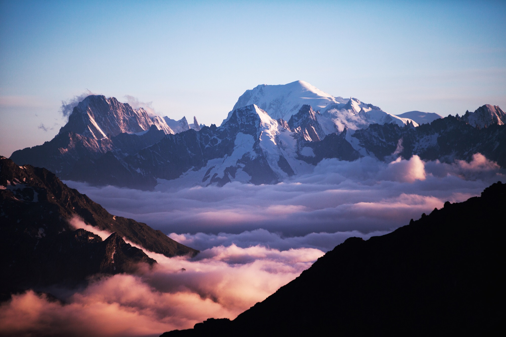 Day 4: Col De Prafleuri Late to Col de Prafleuri at 2,965 meters. Above the clouds the sun lit Mont Blanc and Grand Comin, purpling the clouds below. I had run the day out; a scurry down the glacier like a kid down a sandbox slide. I realized this must be home for the night, trapped by dusk above and boulder fields at each earthly end.