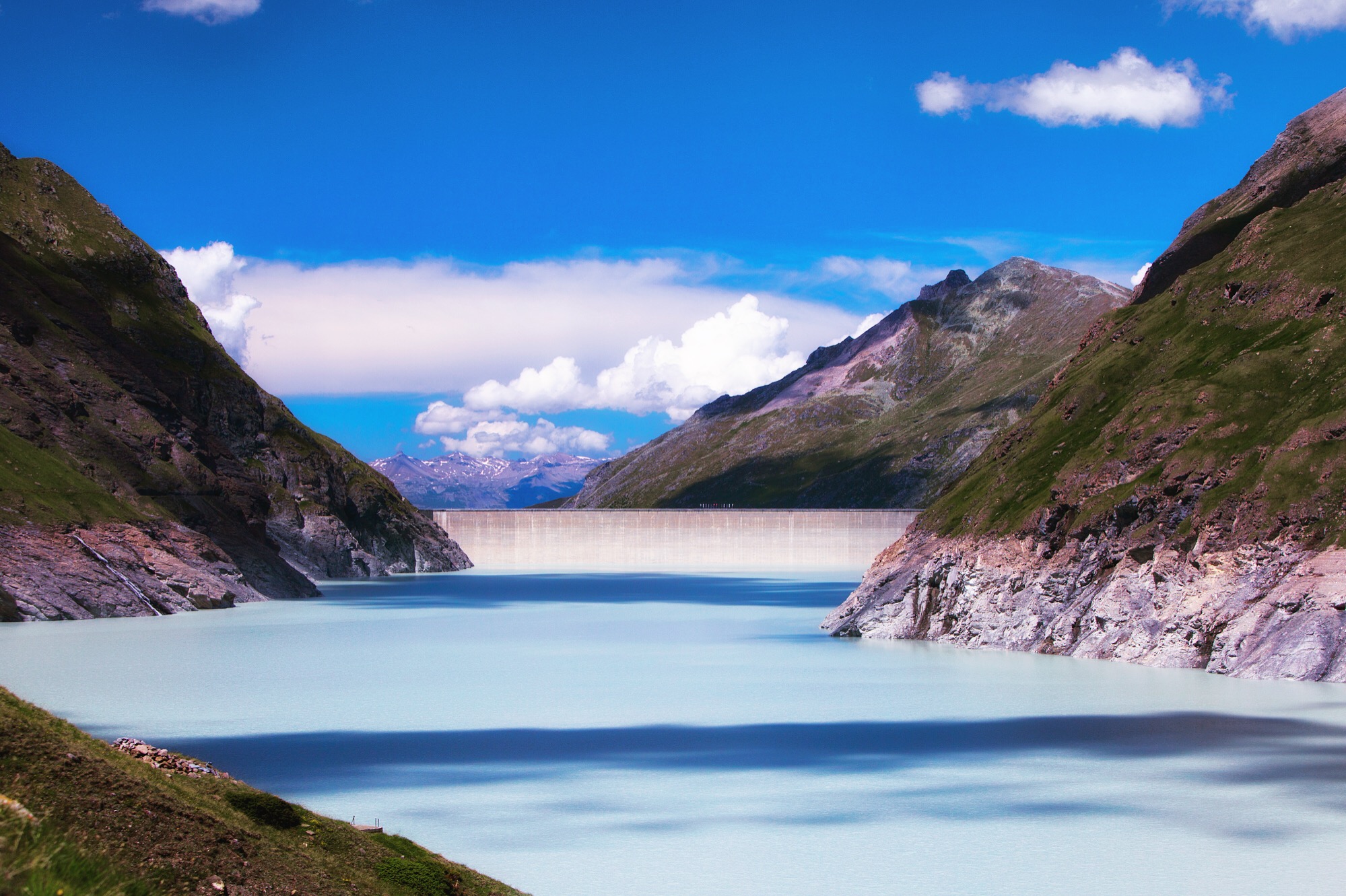 Day 5: Grande Dixence Dam Edging towards Mont Blanc de Cheilon, Lac des Dix engulfs four square kilometers of land at an altitude of 2,364 meters, forted by Grande Dixence Dam at its end. The clouds lay shadows onto the earthy turquoise Glacier runoff.