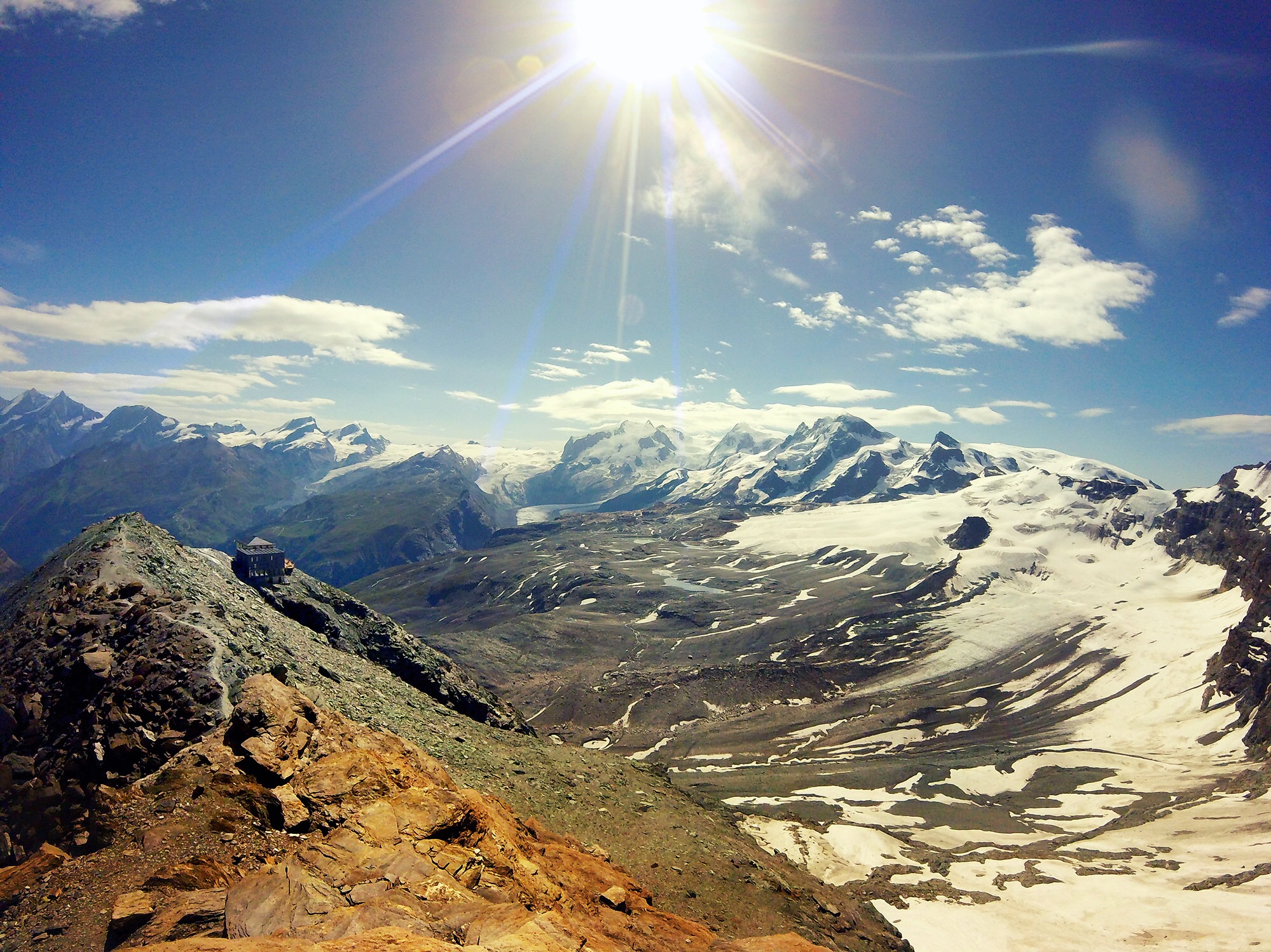 Day 8: Hörnlihütte Looking the other way each the four-thousanders line a horizon. The earthly cataclysms, the human tragedies and triumphs fade together as you imagine taking their peaks on a stroll, from one to the next. To the left sits Hörnlihütte, otherwise the base camp that would begin an early morning bid for the Matterhorn summit.