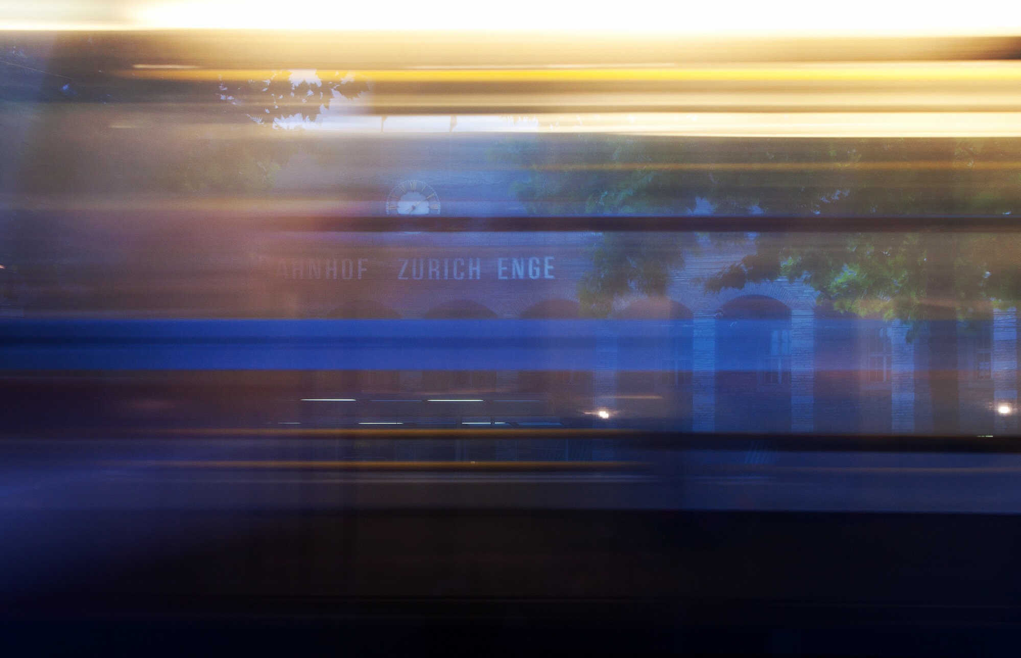 Day 10: Zürich Enge railway station The number five tracks a semicircle in the foreground. Beyond the wet toes of a traveler reading of silk roads, thunder whispers bonne nuit, gute nacht, good night.