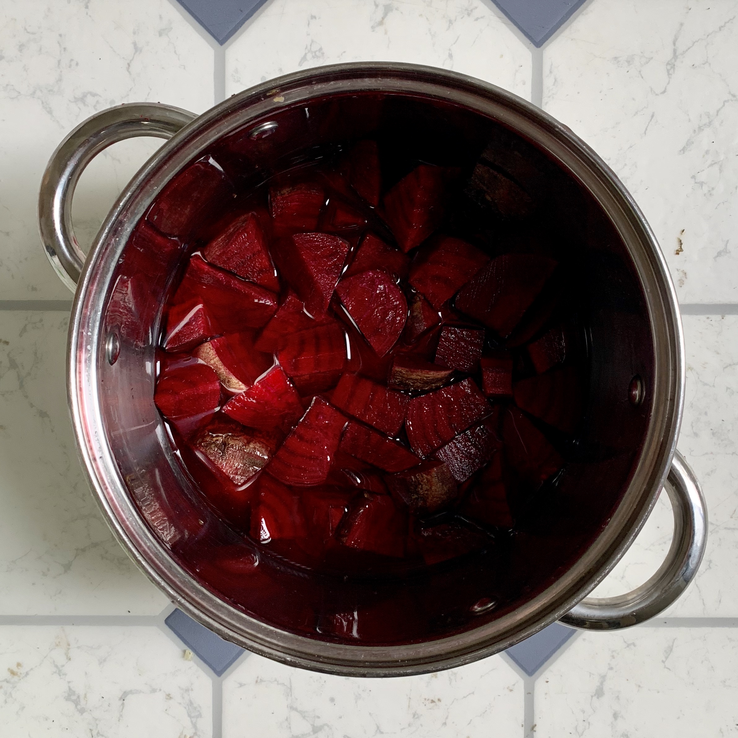 place cut up beets into pot and add water so that they are just covered. Turn stove on to high until water boils, then let simmer for 20 minutes until beets are soft. If beets are not soft yet let simmer for longer. Periodically test the consistency of the beets. You will need to be soft enough to be able to press through a strainer later on.