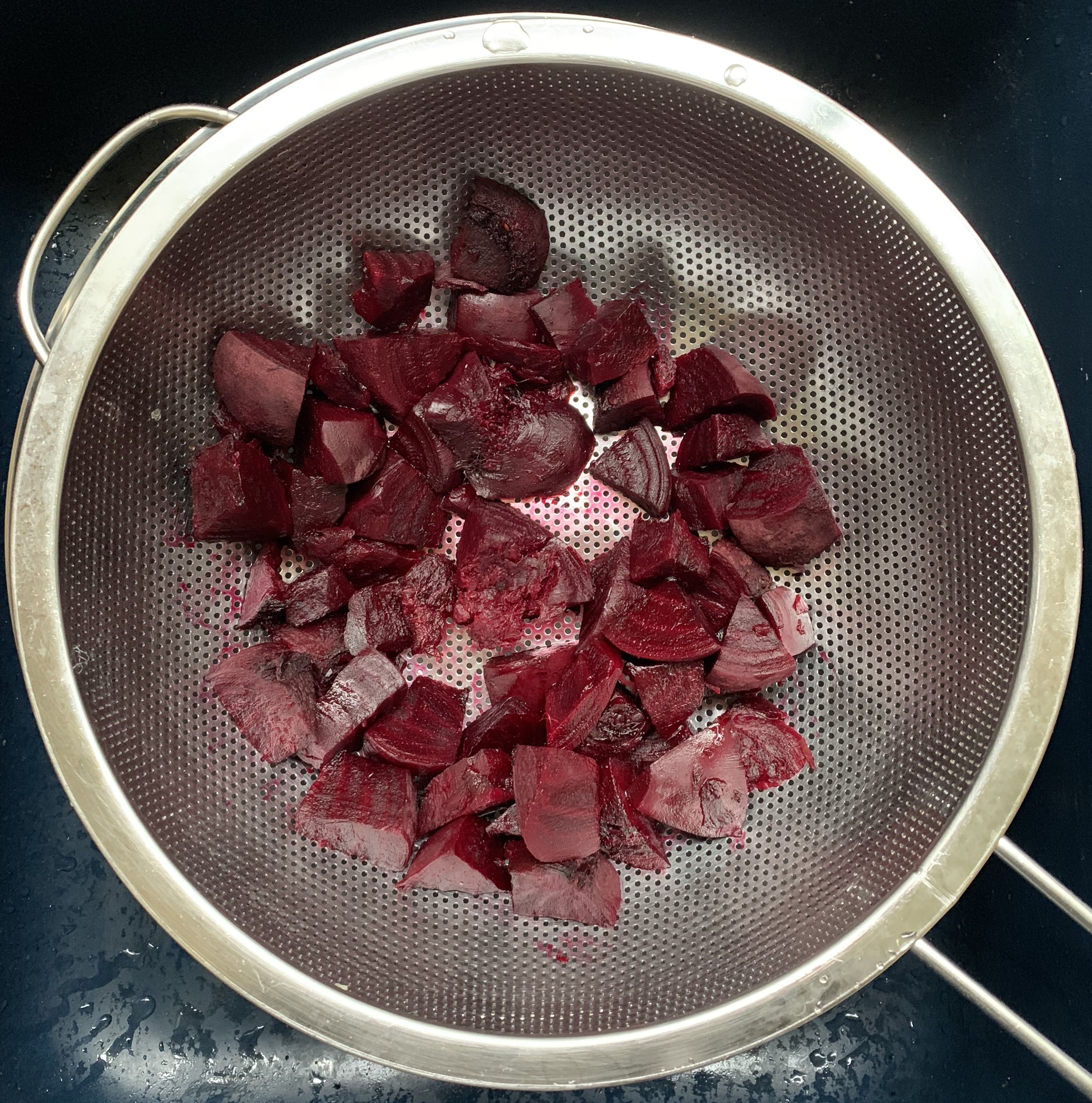 When beets have cooled down sufficiently place them into a mesh strainer and press though into your ink that is beneath the strainer. This adds a thickening consistency to the ink. You don’t need to press all of them through a strainer but just a few from what you cut up.
