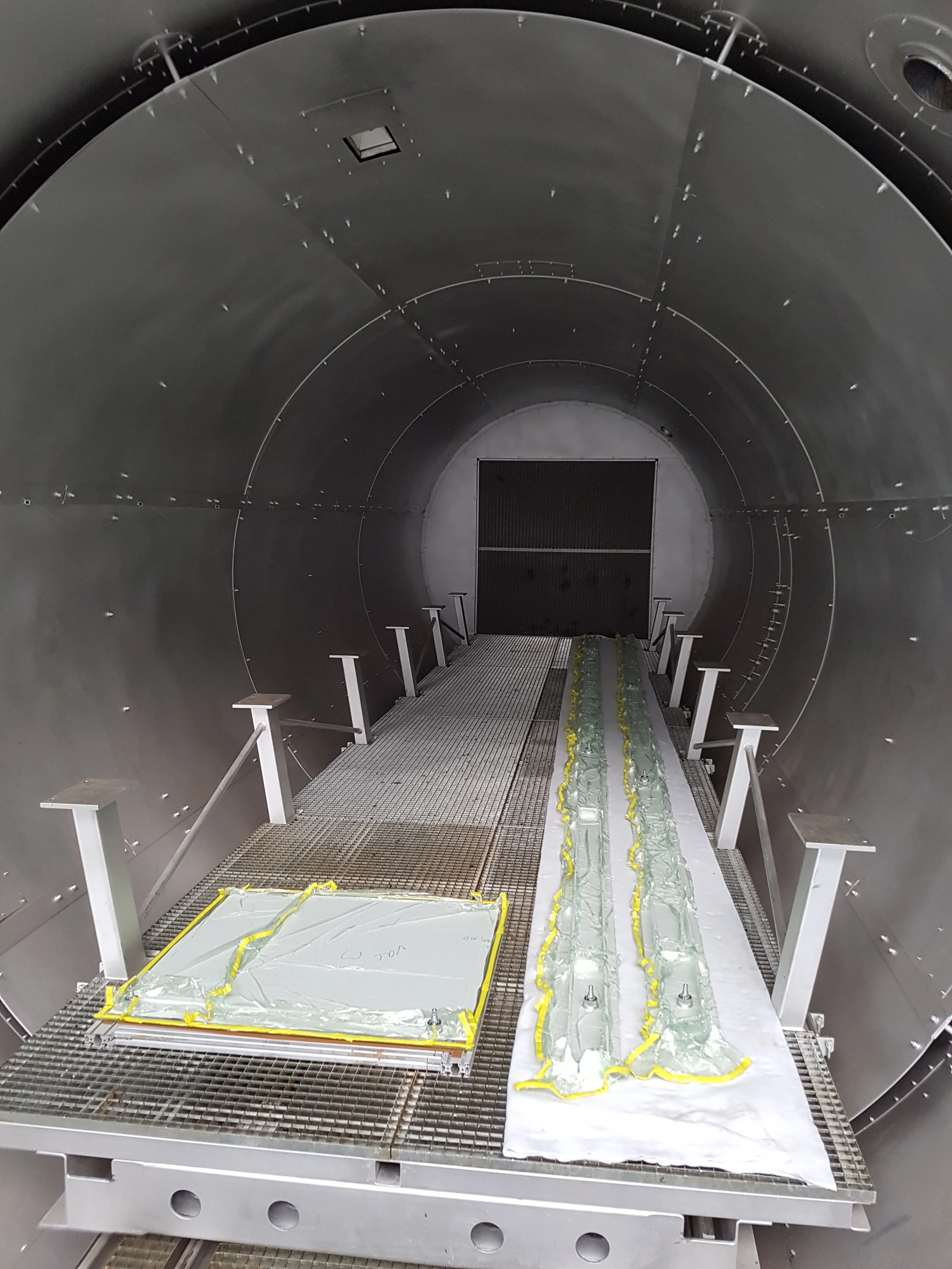 Prepreg planks and panels on the lower shelf of the large autoclave. There are two further levels with vacuum tables up to 3.3m width and 9.9m length.