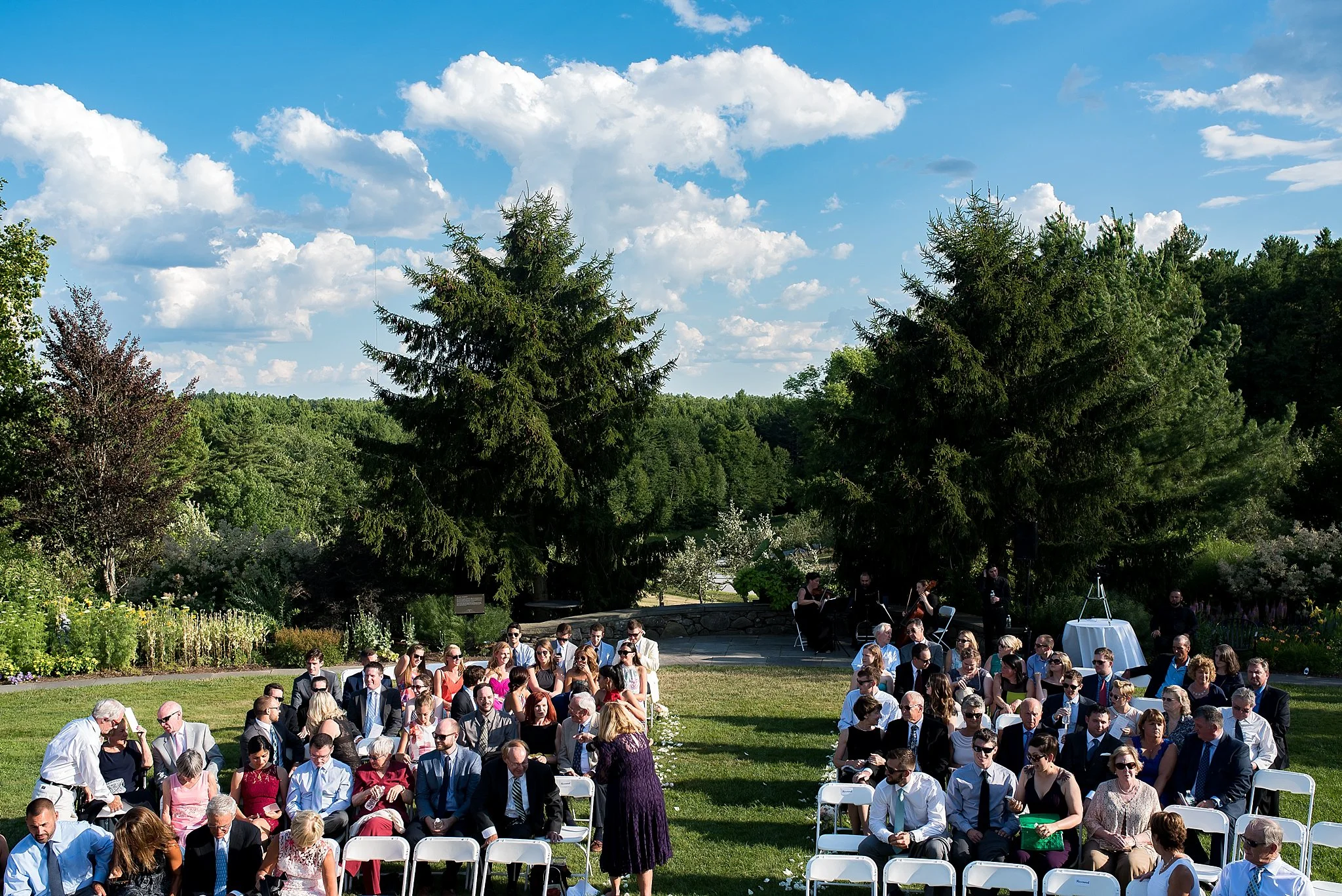 a scenic view of an outdoor ceremony at tower hill botanic garden