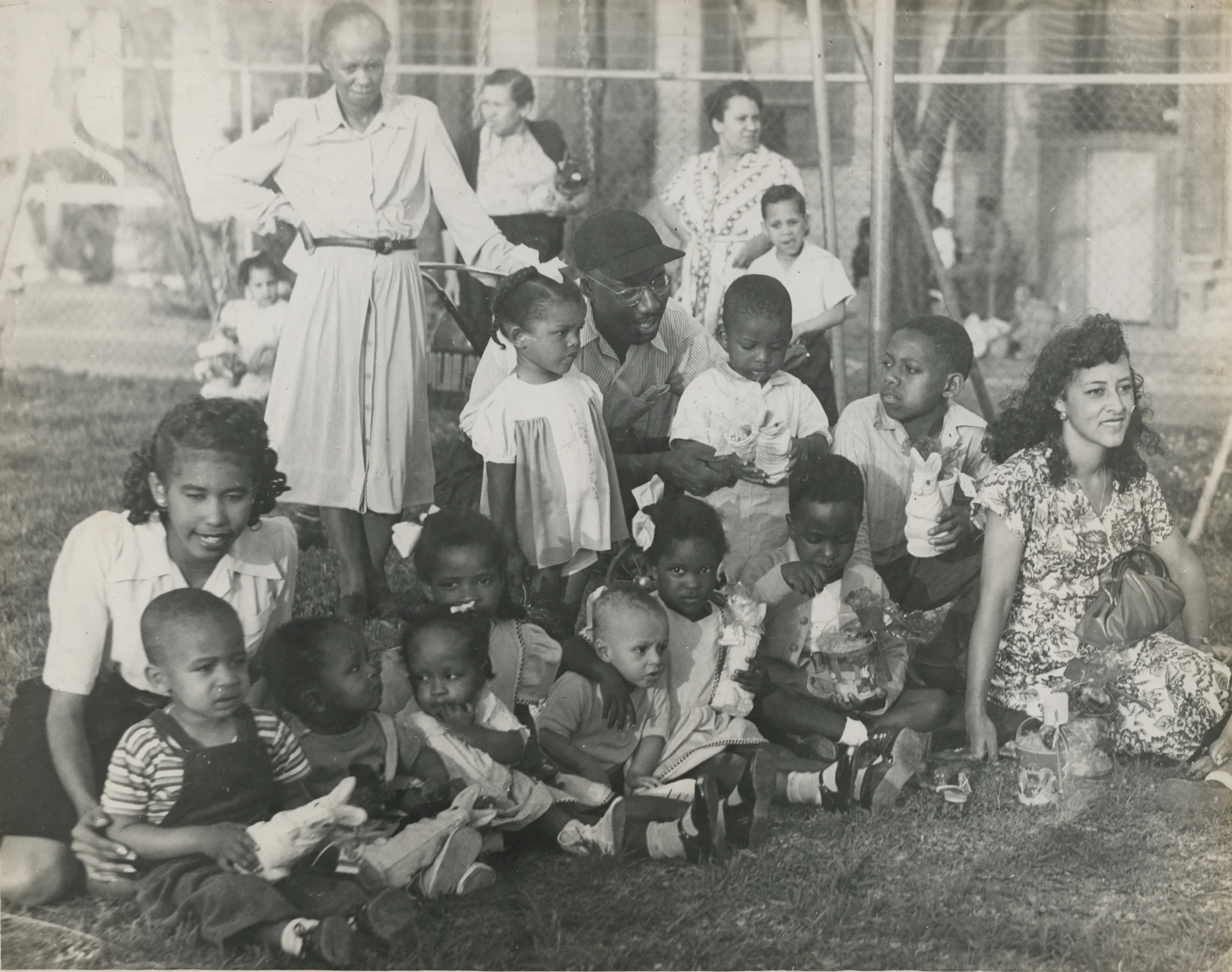 Women and children after receiving their Easter gifts. New Orleans (La.) Recreation Dept. Scrapbook photographs, 1947-1948
