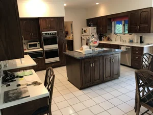 Complete Dark Wood Kitchen Corian Countertops Thermador Black