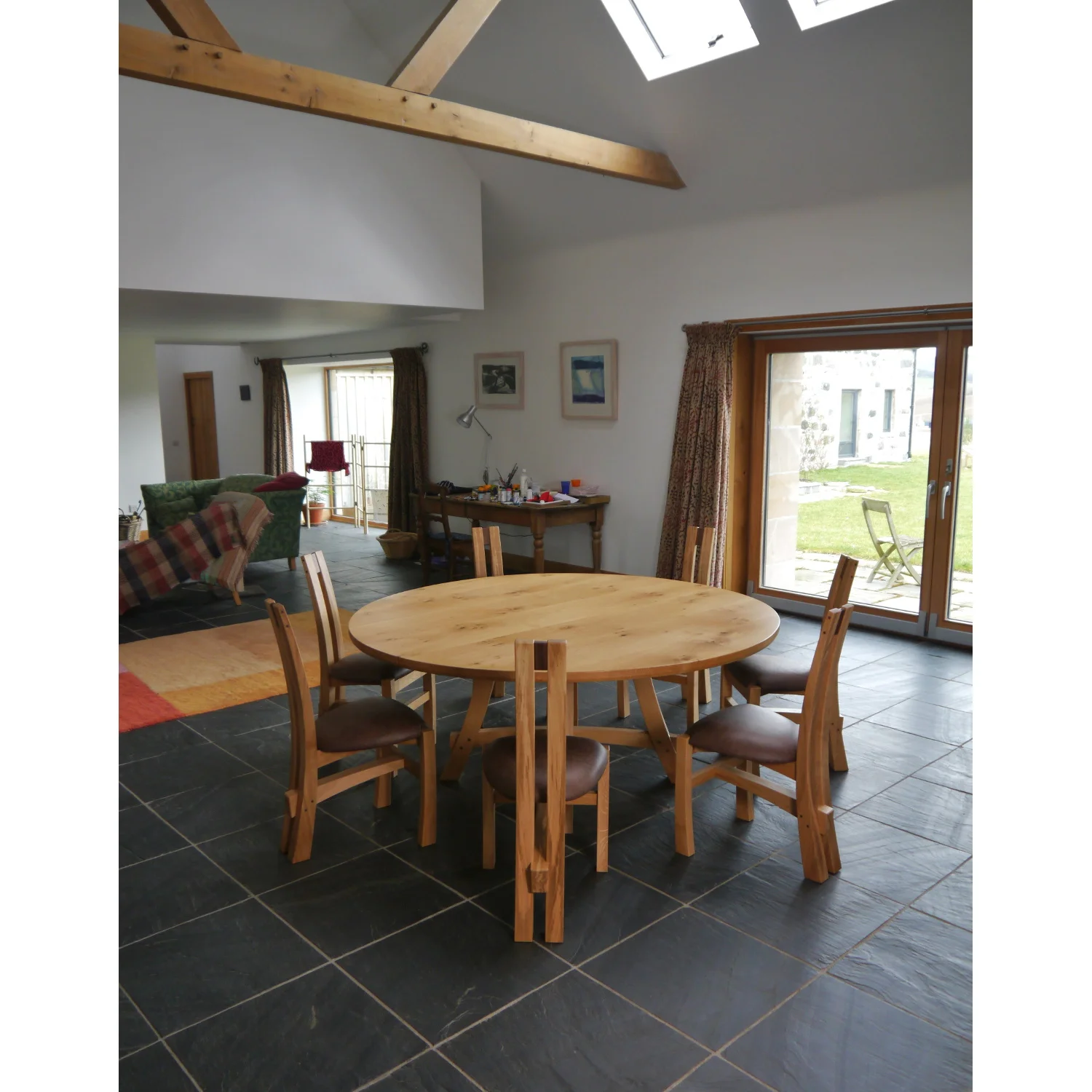 Wide view of Split-leg Dining Table and Chairs in Oak and Leather by Alasdair Wallace
