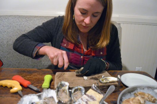 Kate Livie, author of the new book "Chesapeake Oysters: The Bay's Foundation and Future," shucks an Old Black Salt oyster at Pearl Dive Oyster Palace in Washington.
