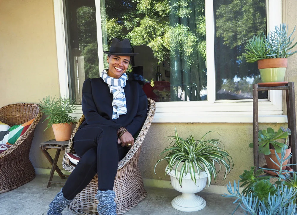 Karen Gibson Roc photographed at home for THE TROVE as her dog Boo-Boo looks on.