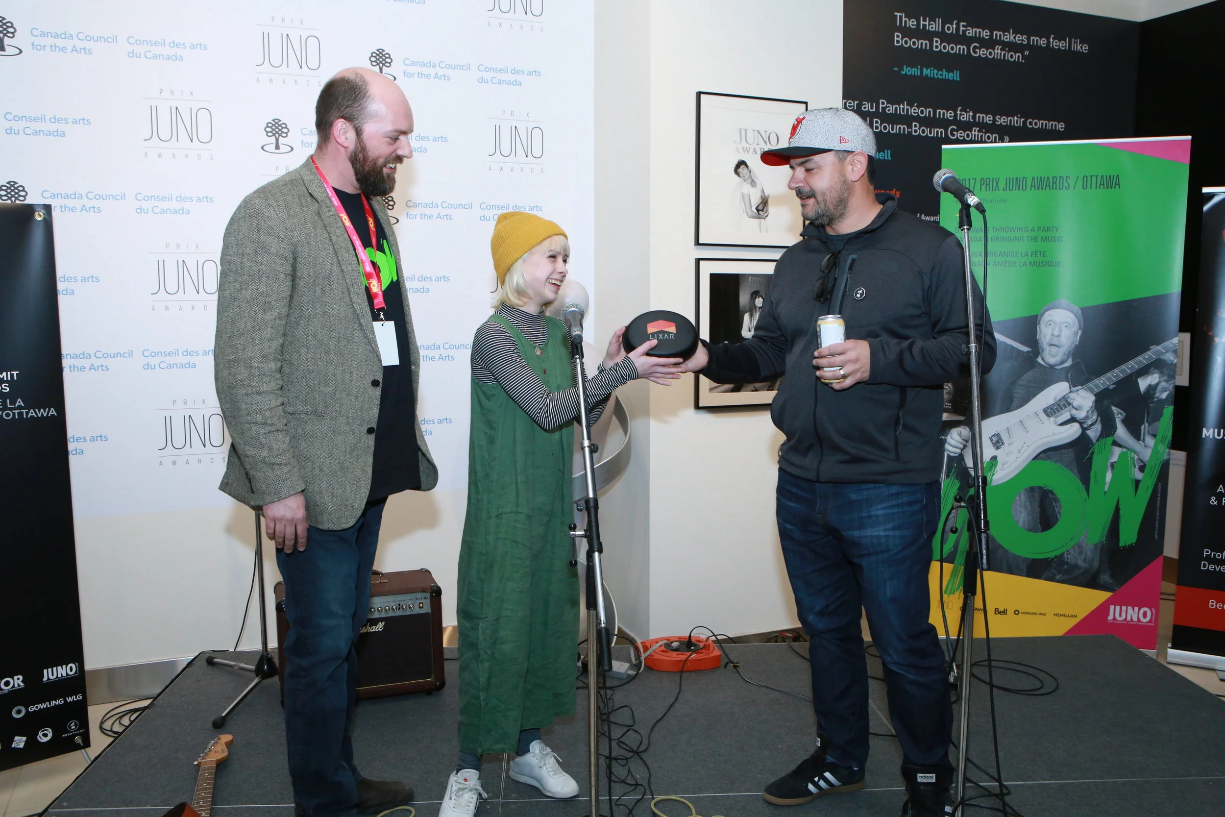 Allie O'Manique (Trails) presented with Lixar headphones by company CEO Bill Syrros and MEGAPHONO director Jon Bartlett at the Ottawa Music Summit at the Junos. (photo: John Major).