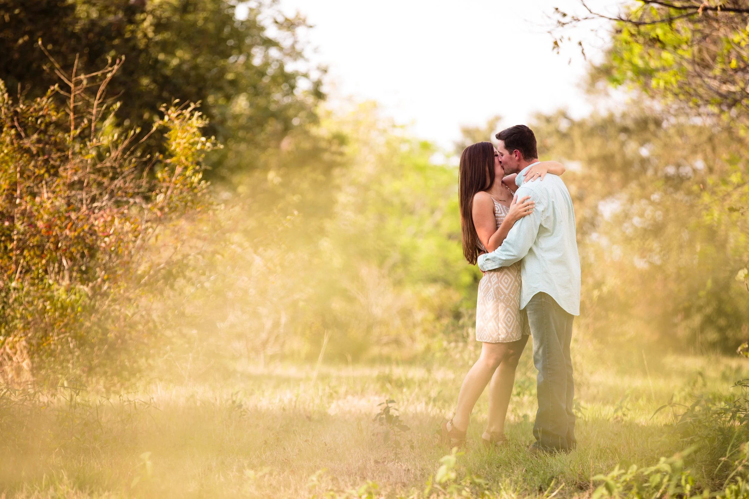 Couple Kiss Outdoors - Summer Engagement Portrait