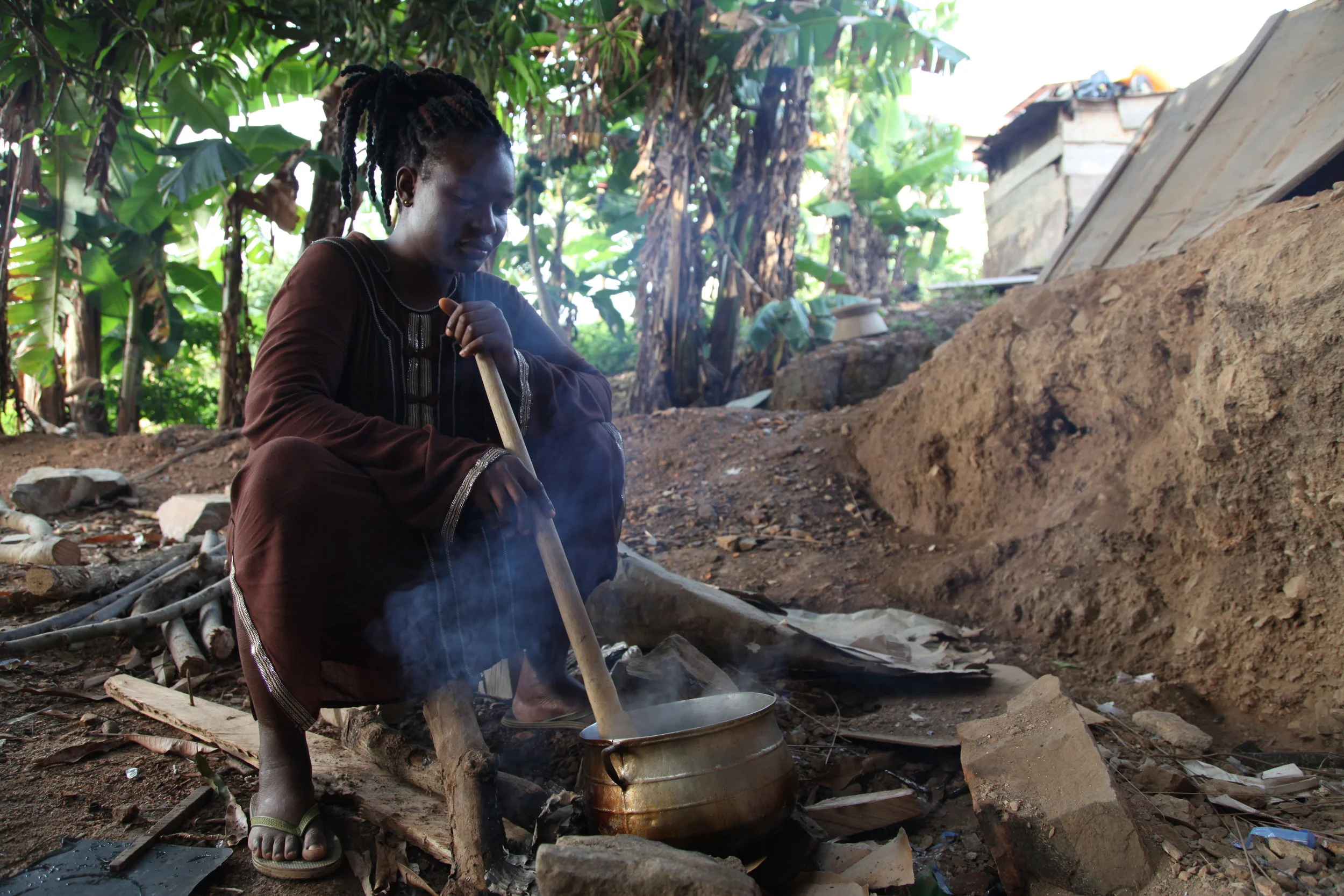 Ghanaian woman cooking with firewood.JPG