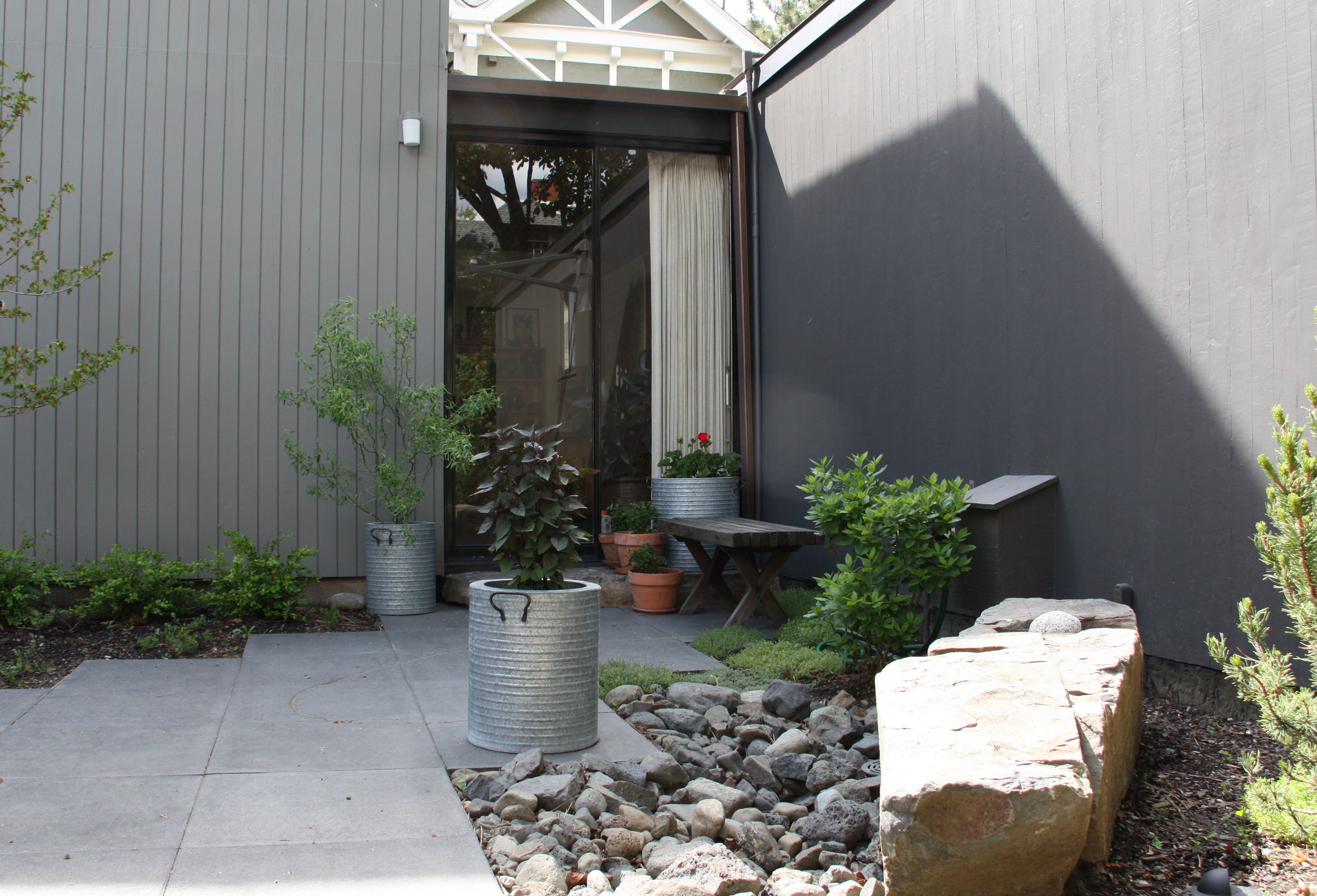 square paver patio with container plants