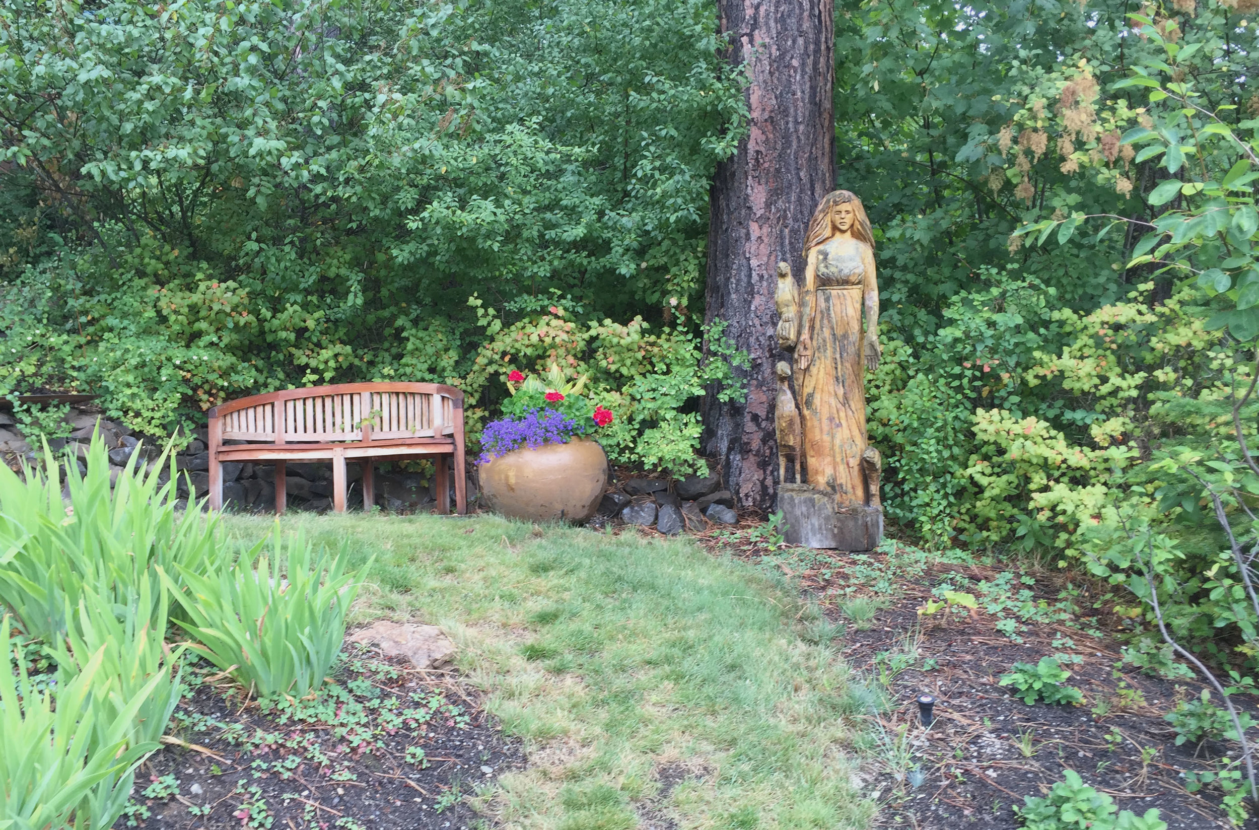 bench and statue on mown grass path