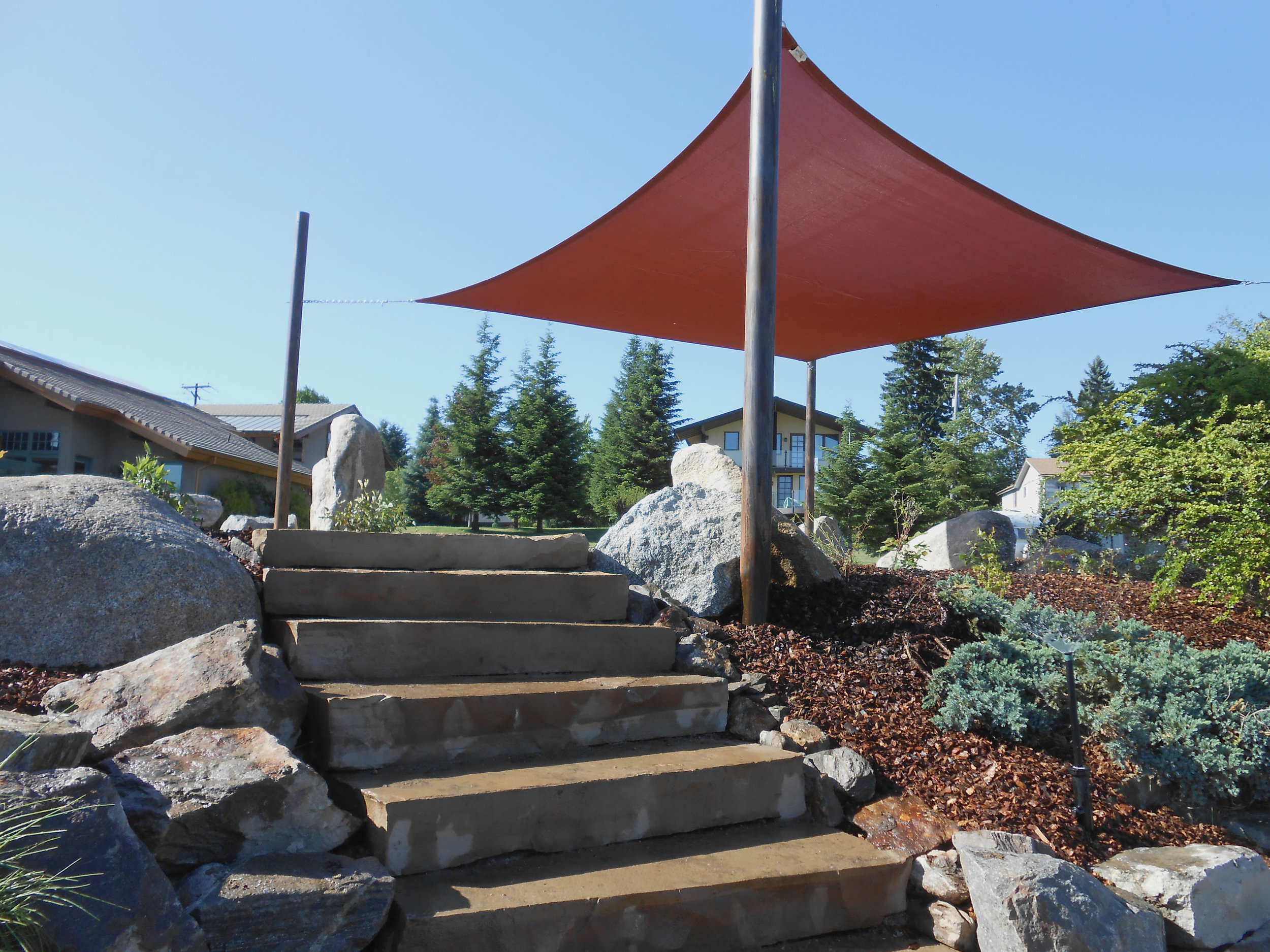 square shade sail and stone steps