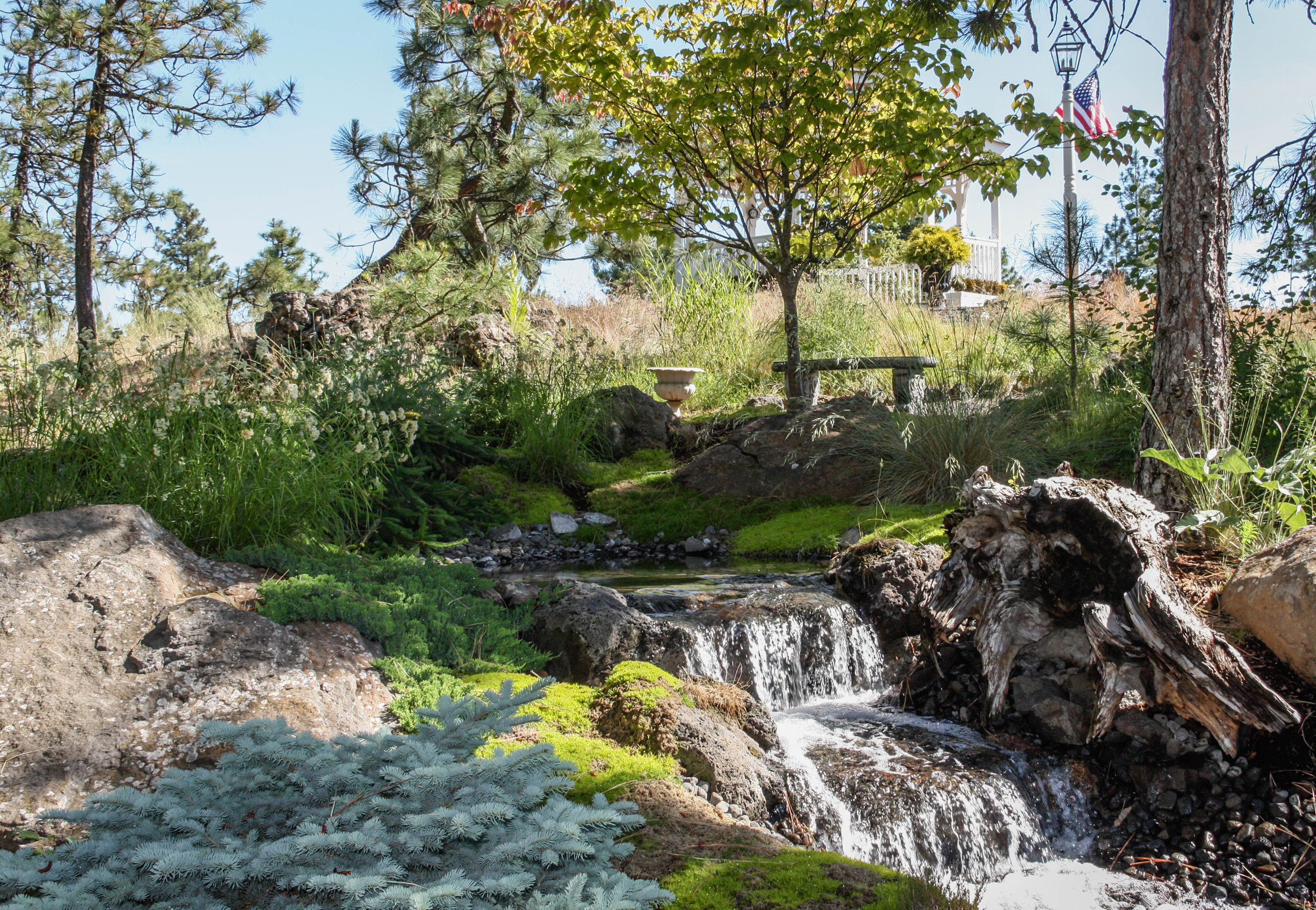 sitting area by natural stream water feature spokane landscape