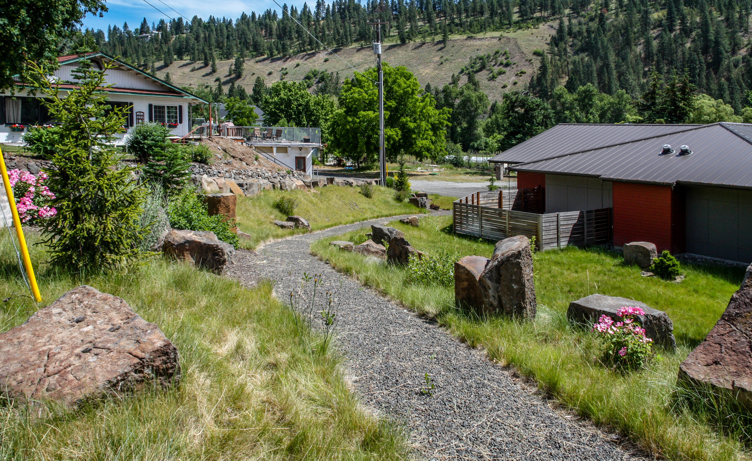 gravel pathway down hillside with basalt columns