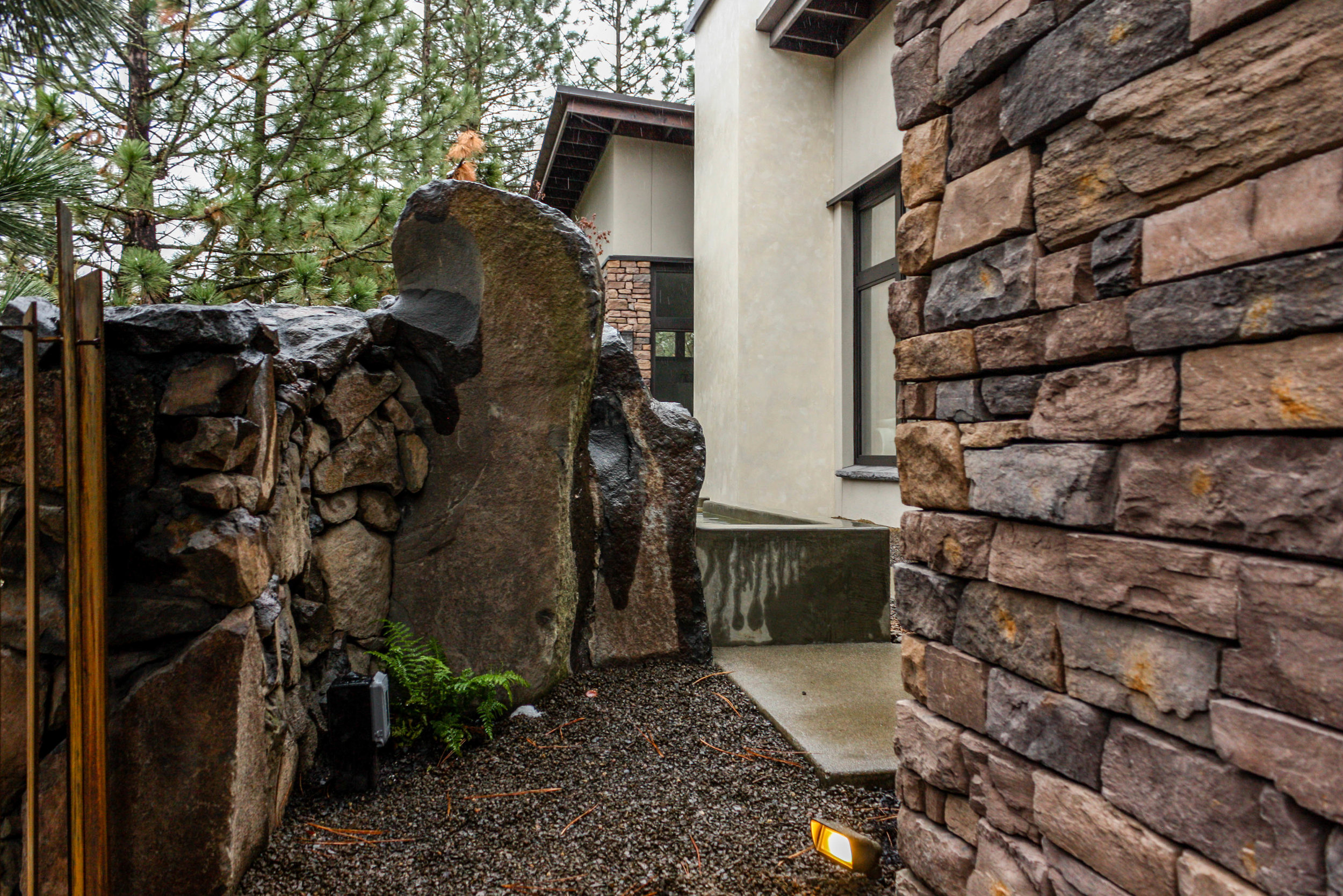 basalt wall integrated with water feature in spokane south hill landscape