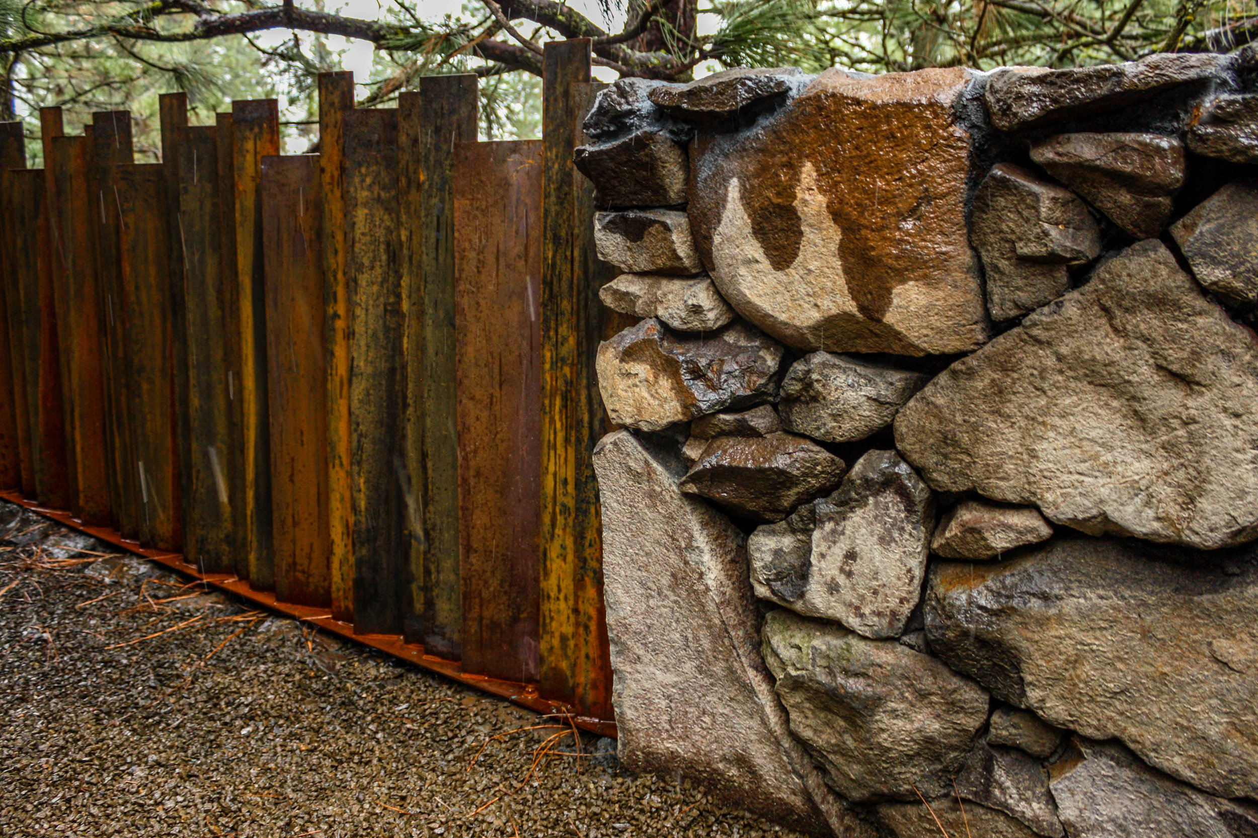 natural basalt wall and corten metal fence on spokane south hill