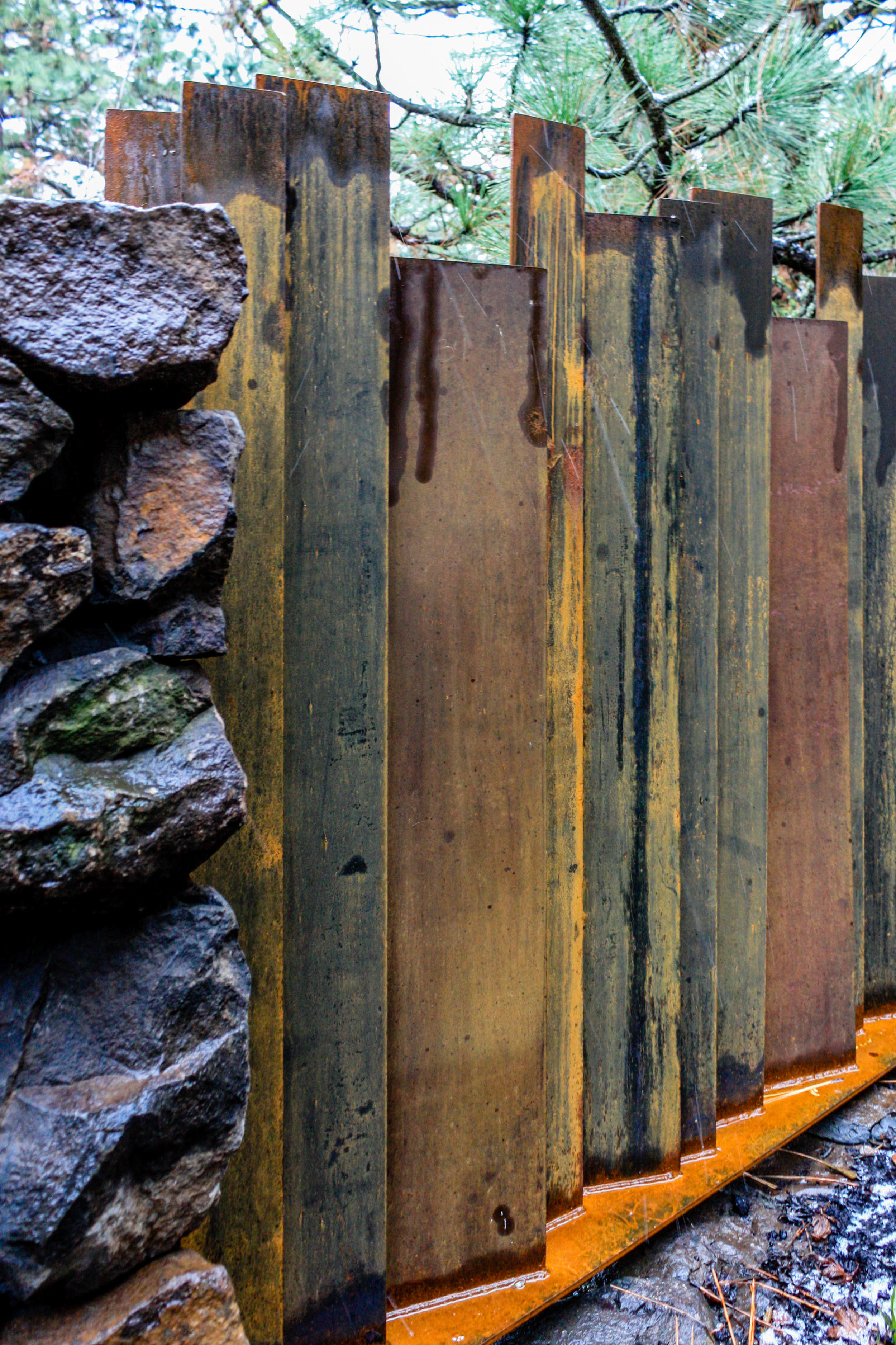 corten steel fence and basalt wall