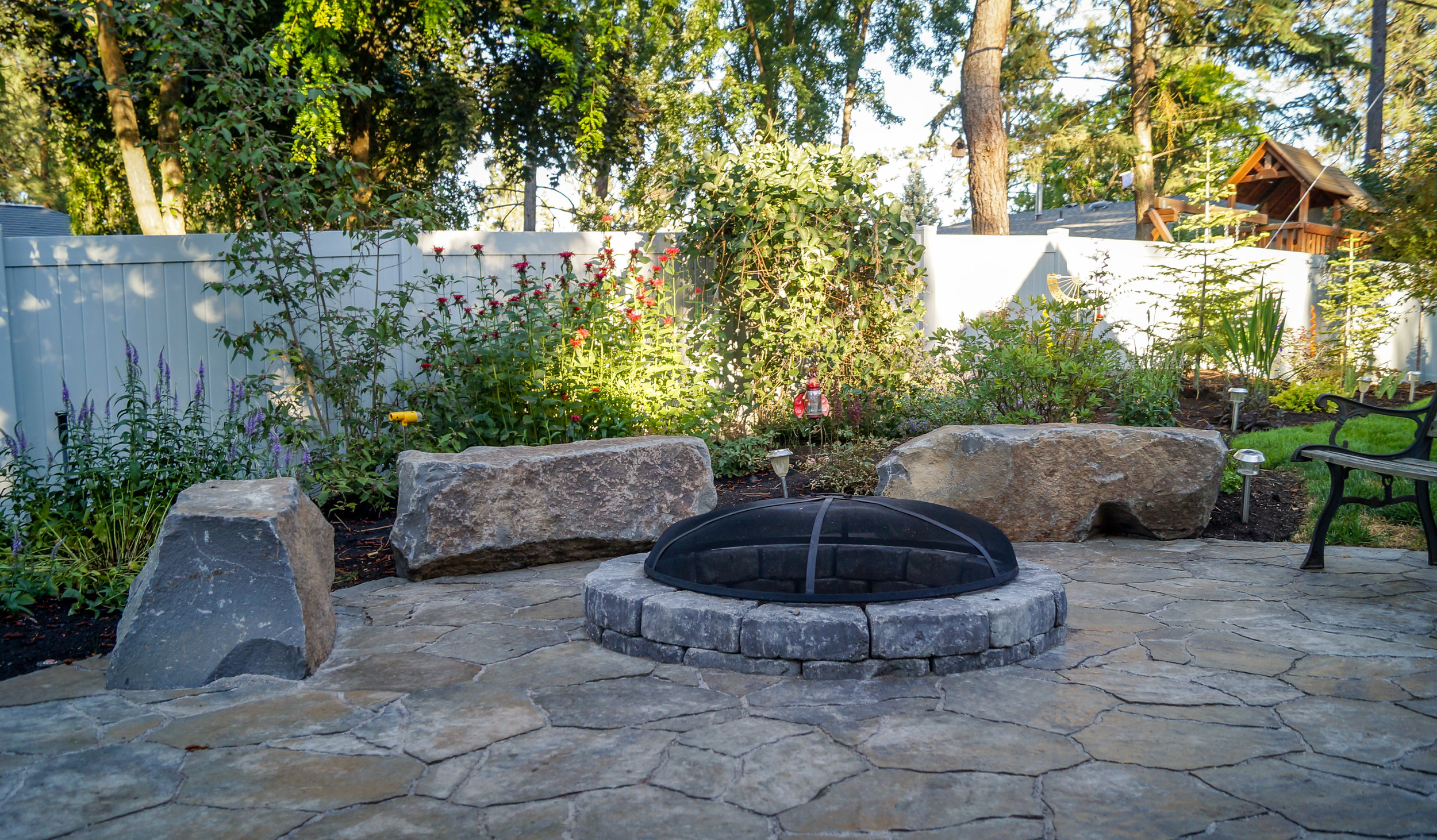 belgard mega arbel paver patio with basalt column bench rocks around fire pit on spokane south hill