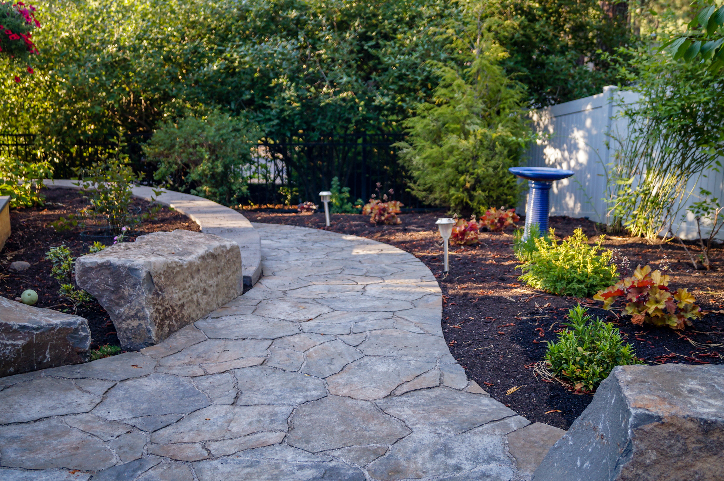belgard mega arbel paver pathway around retaining wall and boulders with northwest landscaping