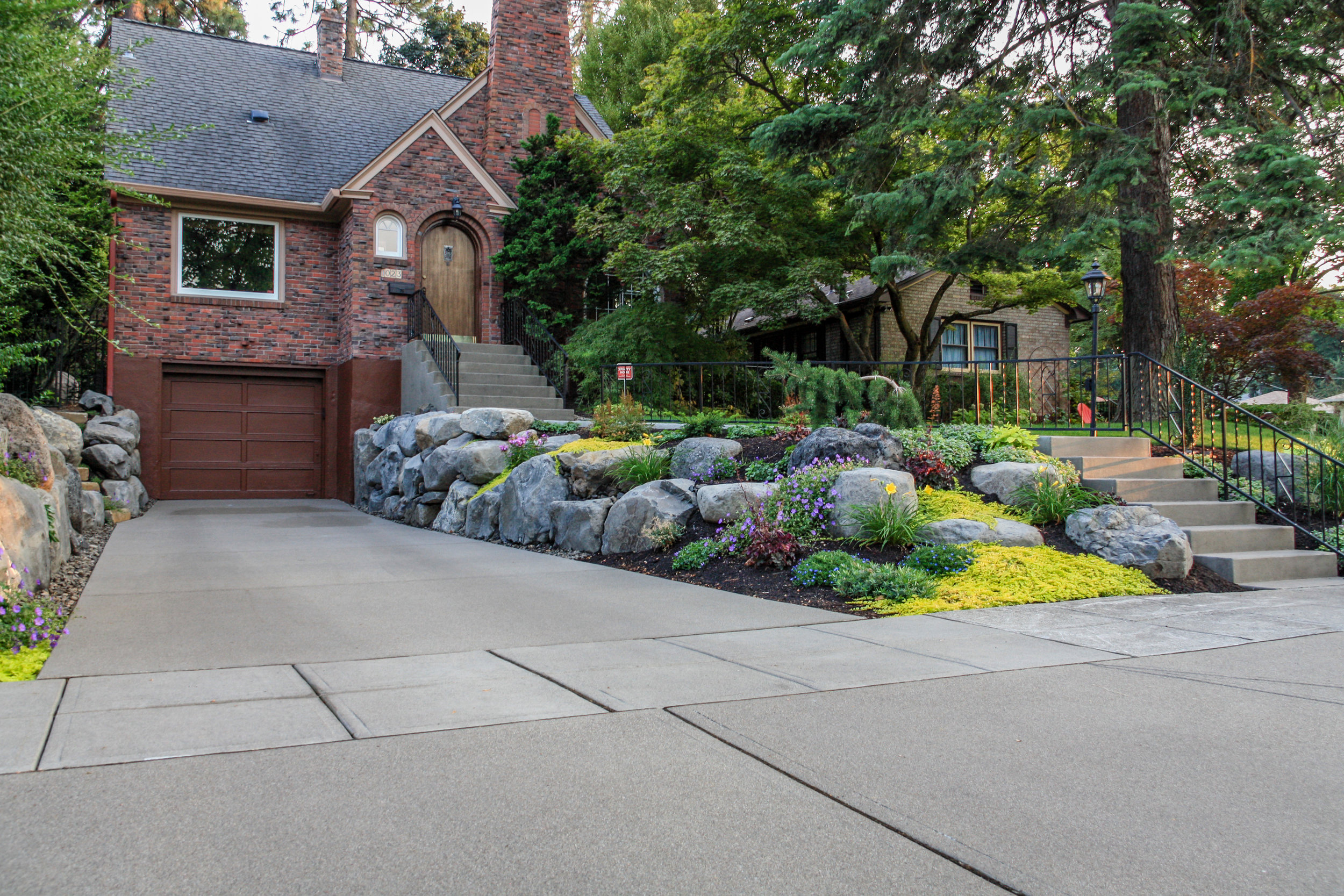 sandwashed driveway and boulder retaining walls