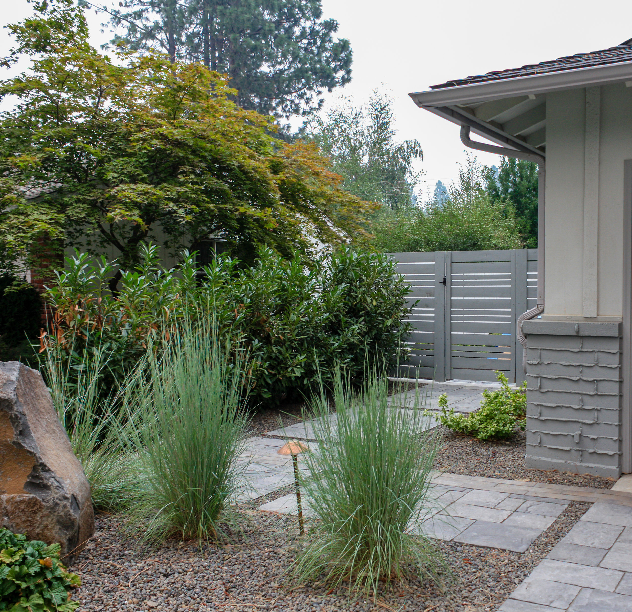 spokane landscape with paver walkway and horizontal wood fence