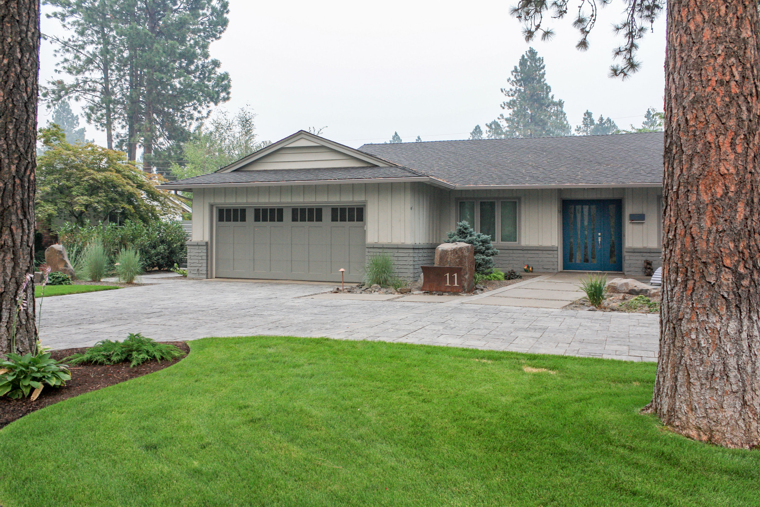 mid century modern ranch house with landscaping