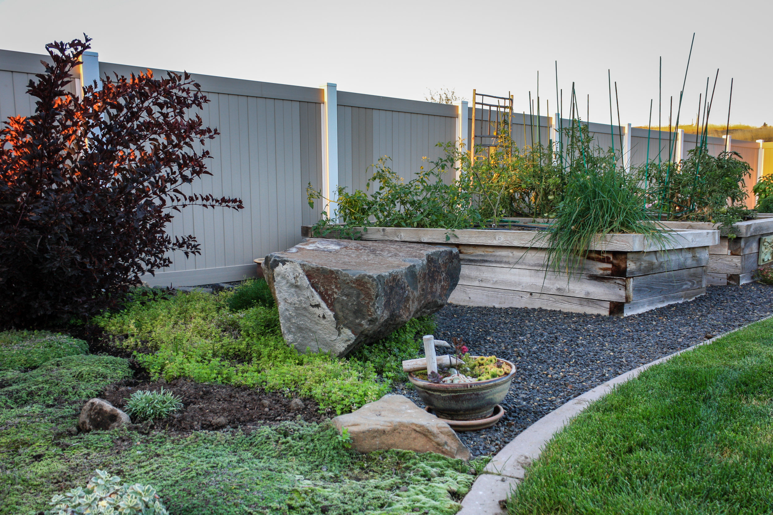 stone bench rock with wood raised vegetable garden boxes