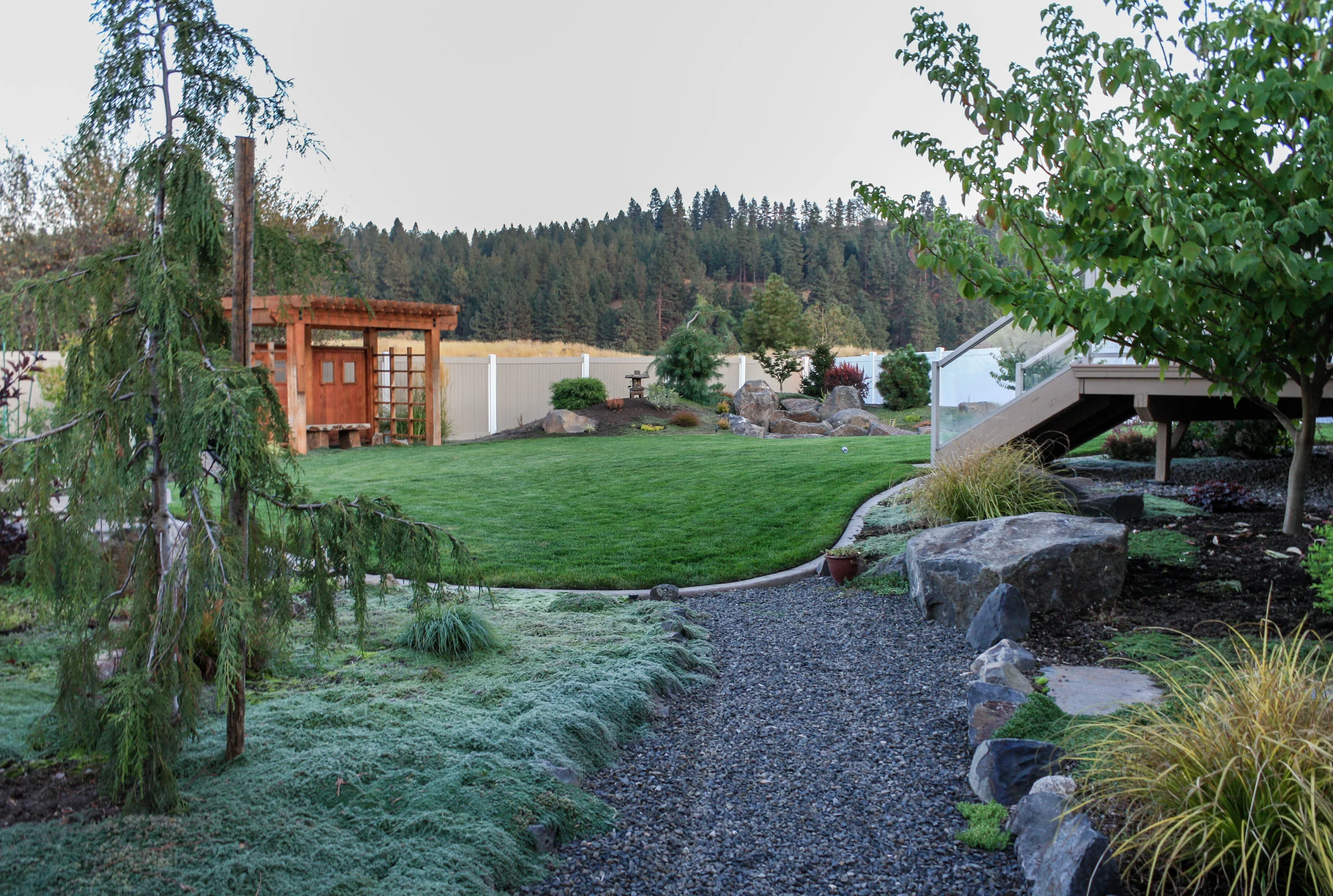 spokane valley asian landscaping with pergola and dry water feature