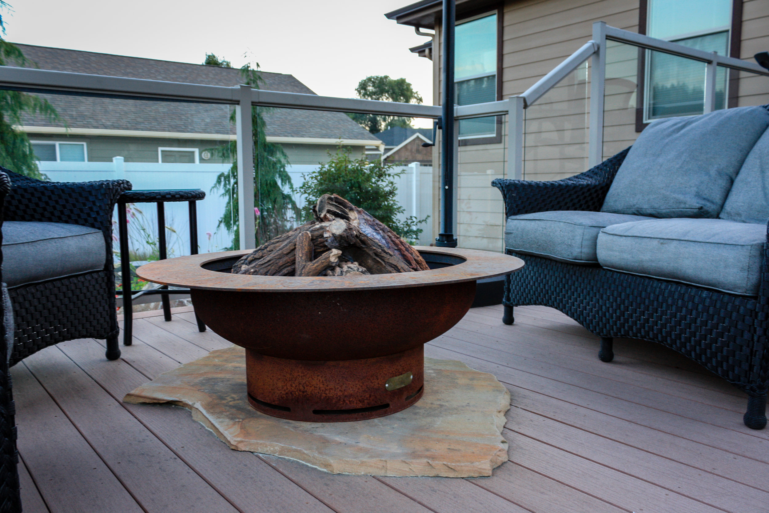 gas fire pit on deck with sandstone slab