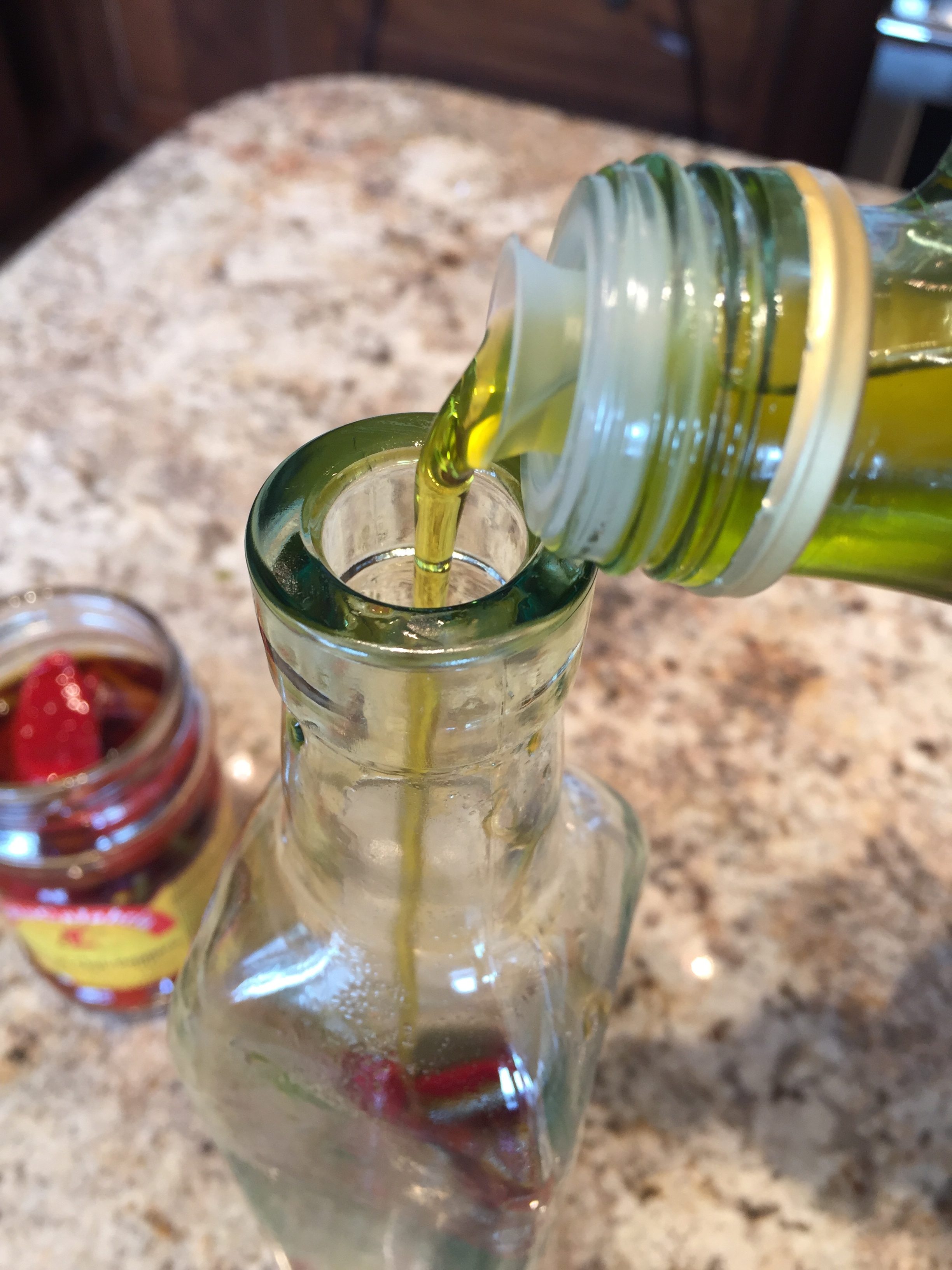 Add chili peppers and olive oil to dispenser.