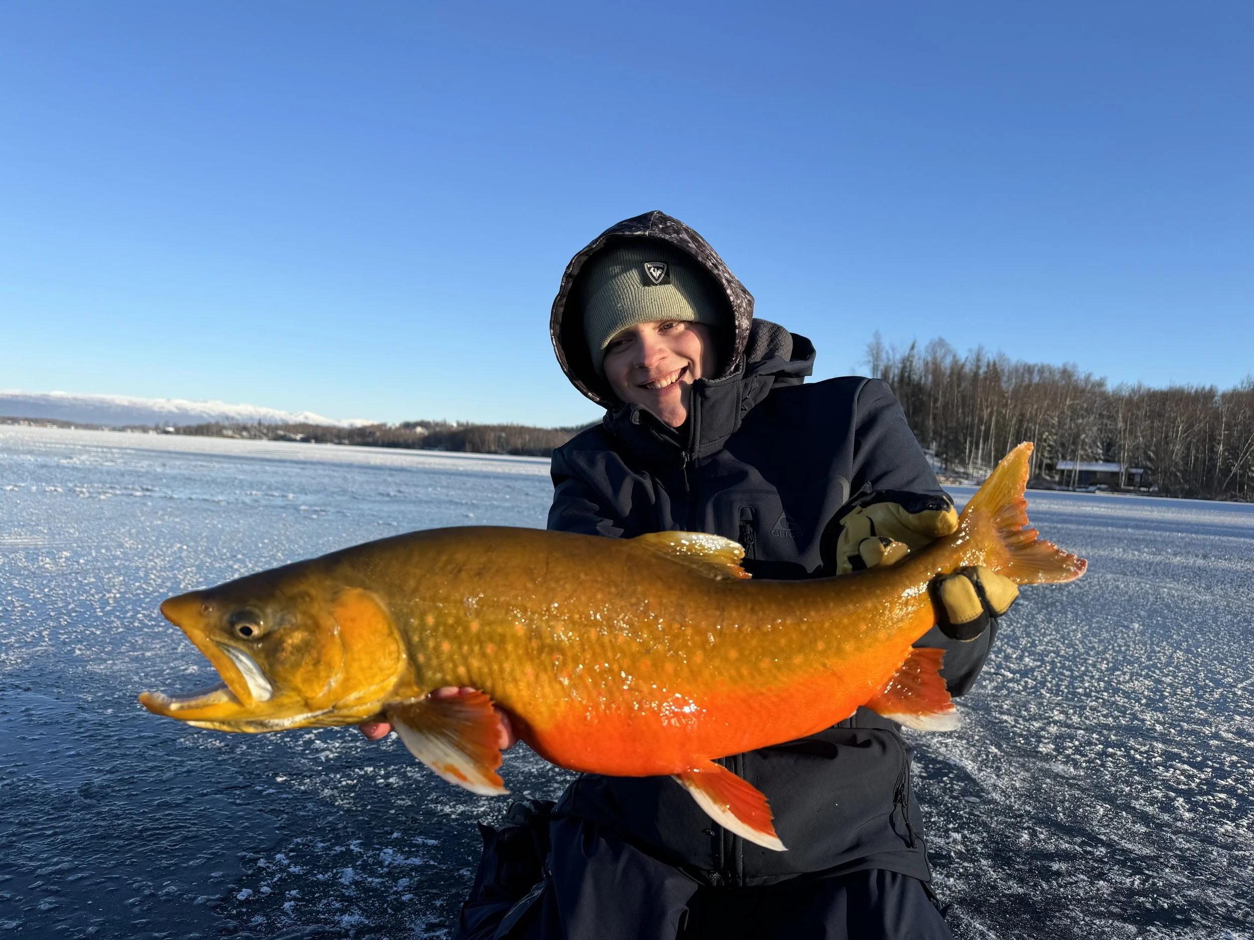 ice fishing guide holding large fish