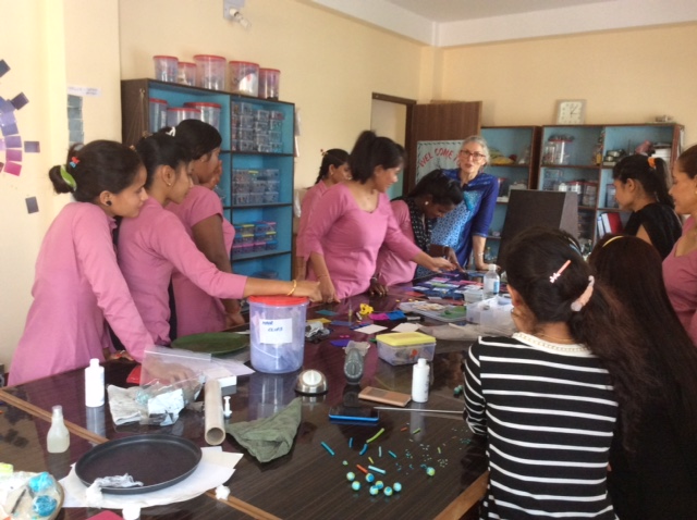 Wendy at the head of the table wearing some sort of Cyan, and her students in made-to-match Magenta