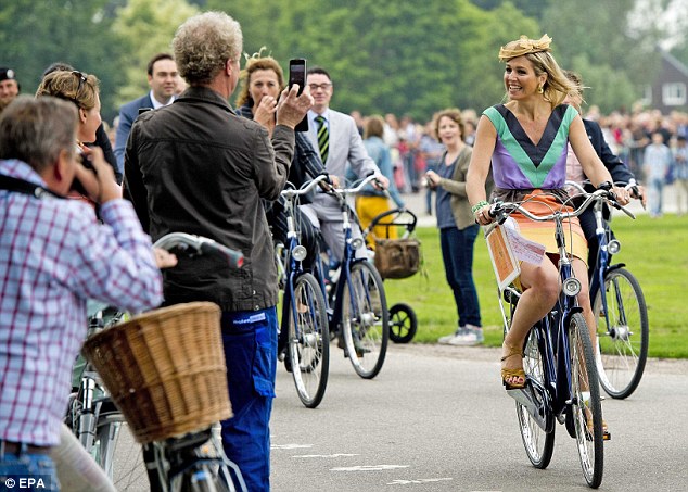 Queen Maxima of the Netherlands, arriving at an official function on her bike.