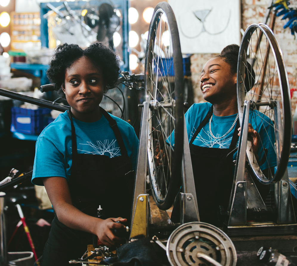 Nayla Hale (left), 16, giving someone some serious side-eye, and Khori Wilson, 13, repair newbies to master bike mechanics