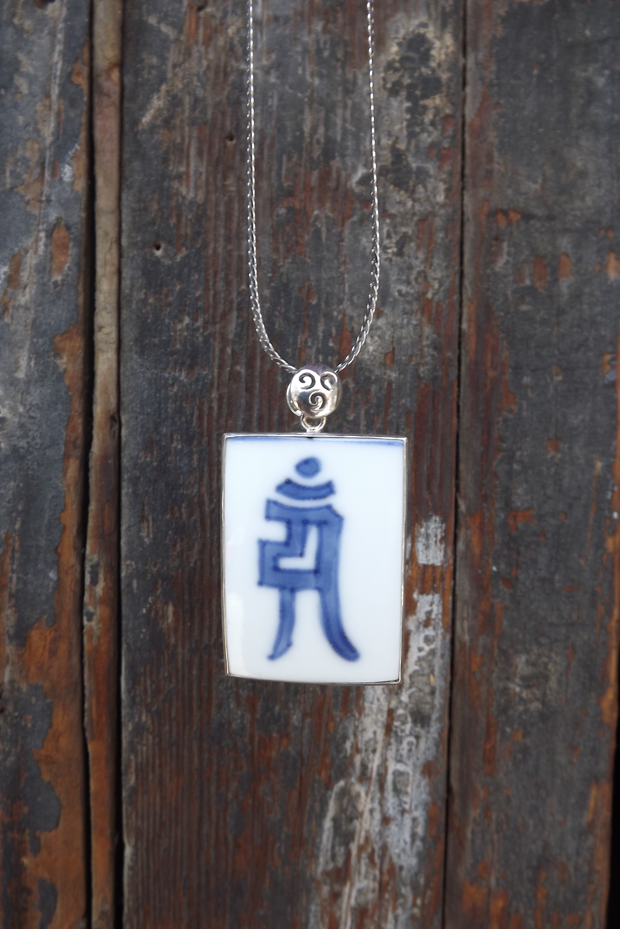 Blue and white sanskrit pendant