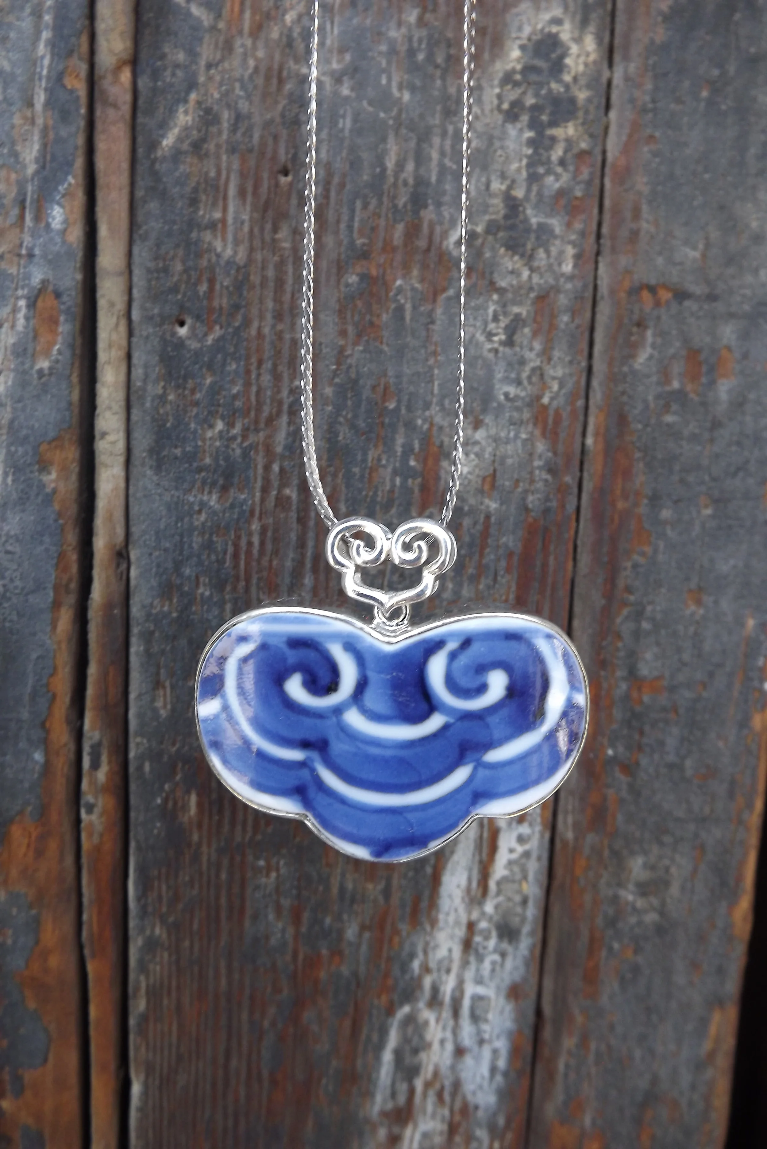 Blue and white mascot pendant
