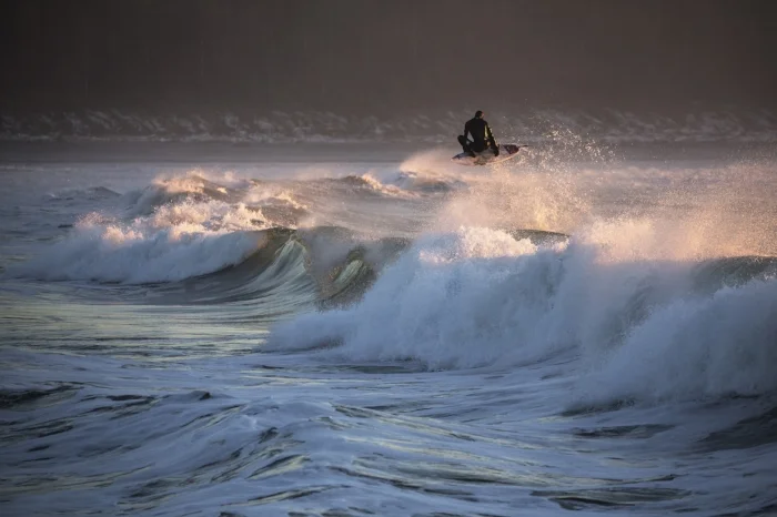 January 5th - Tofino had some crazy dry spells in the month of January, the lack of rain and sub-zero temperatures caused anywhere that didn't get hit by the sun (or lack there of) to freeze over. Hence all the frost in the background on the beach. Surfer: Pete Devries This image can be found in the winter issue of Coast Mountain Culture.