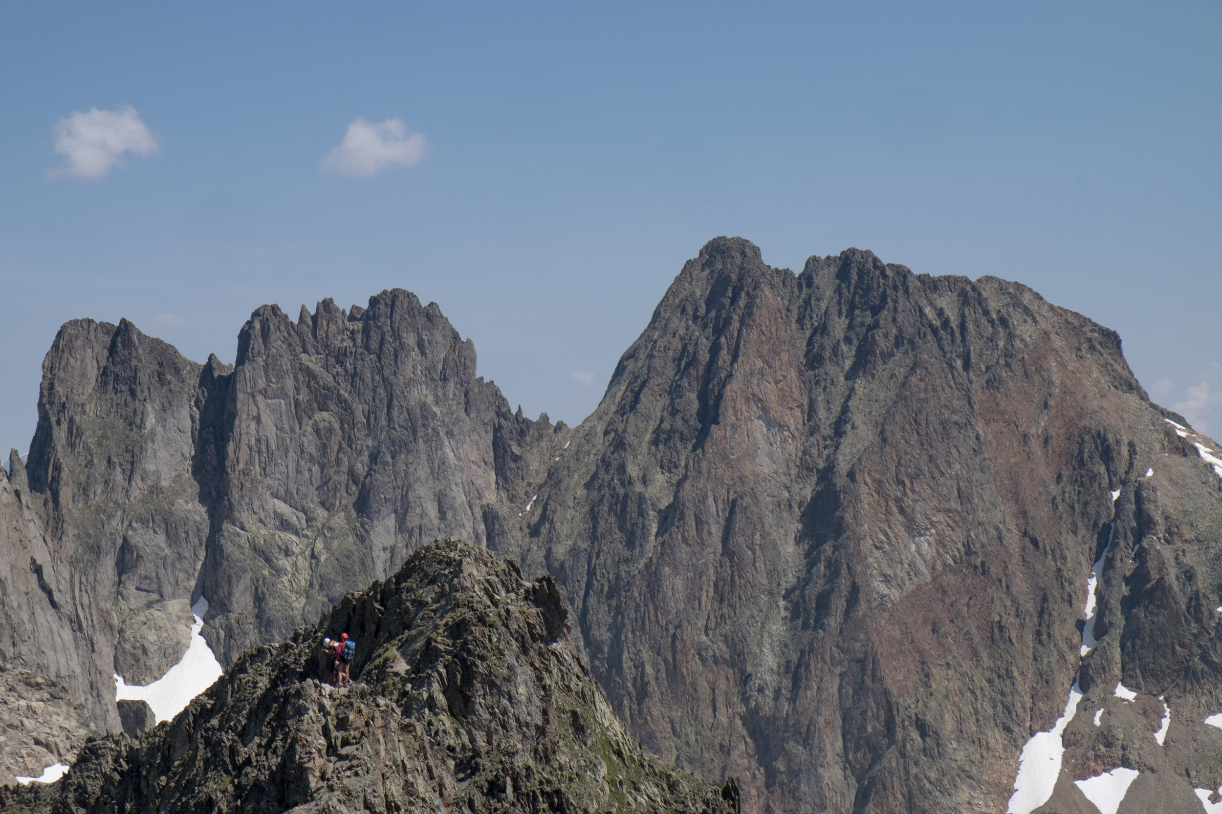 Two climbers descend from the Crochues traverse.